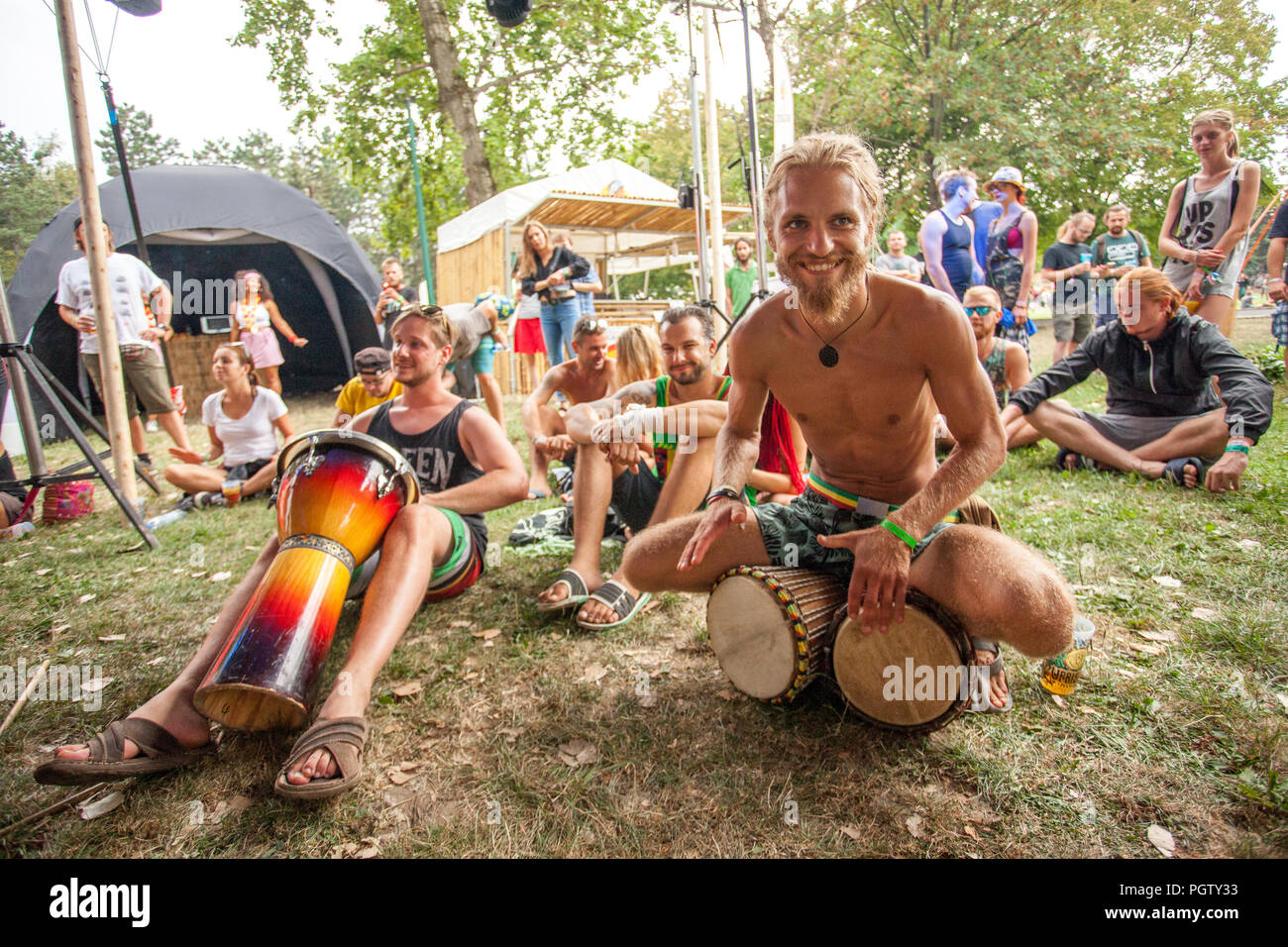 Bratislava, Slovakia. 24th August, 2018. Visitors to the Uprising Music Festival drum and enjoy their time. Stock Photo