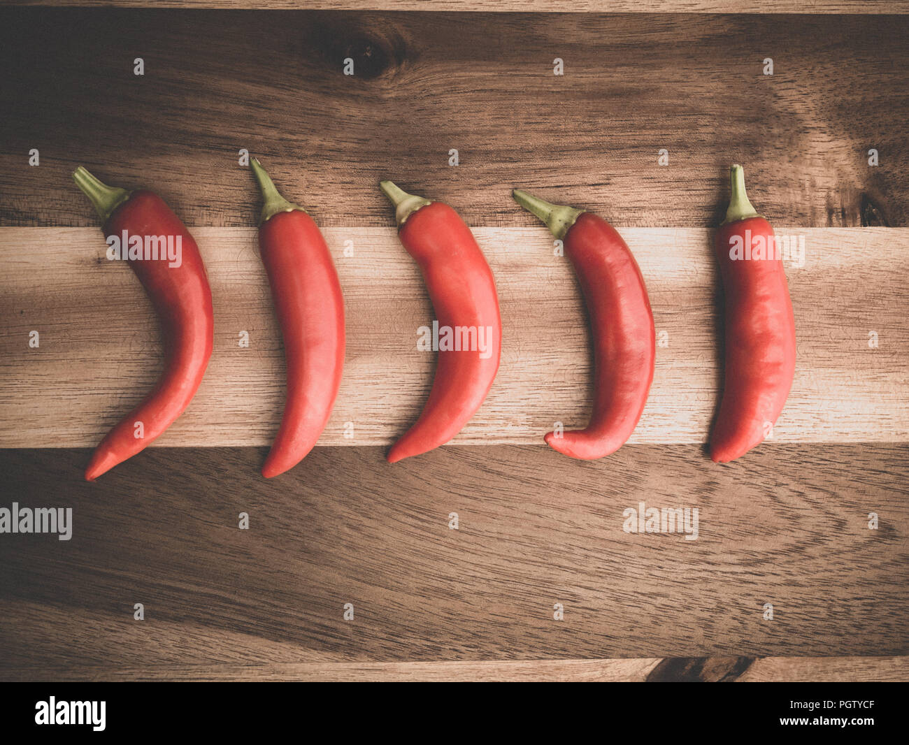 Decoration Of Red Chili Peppers On Wodden Board Set Stock Photo