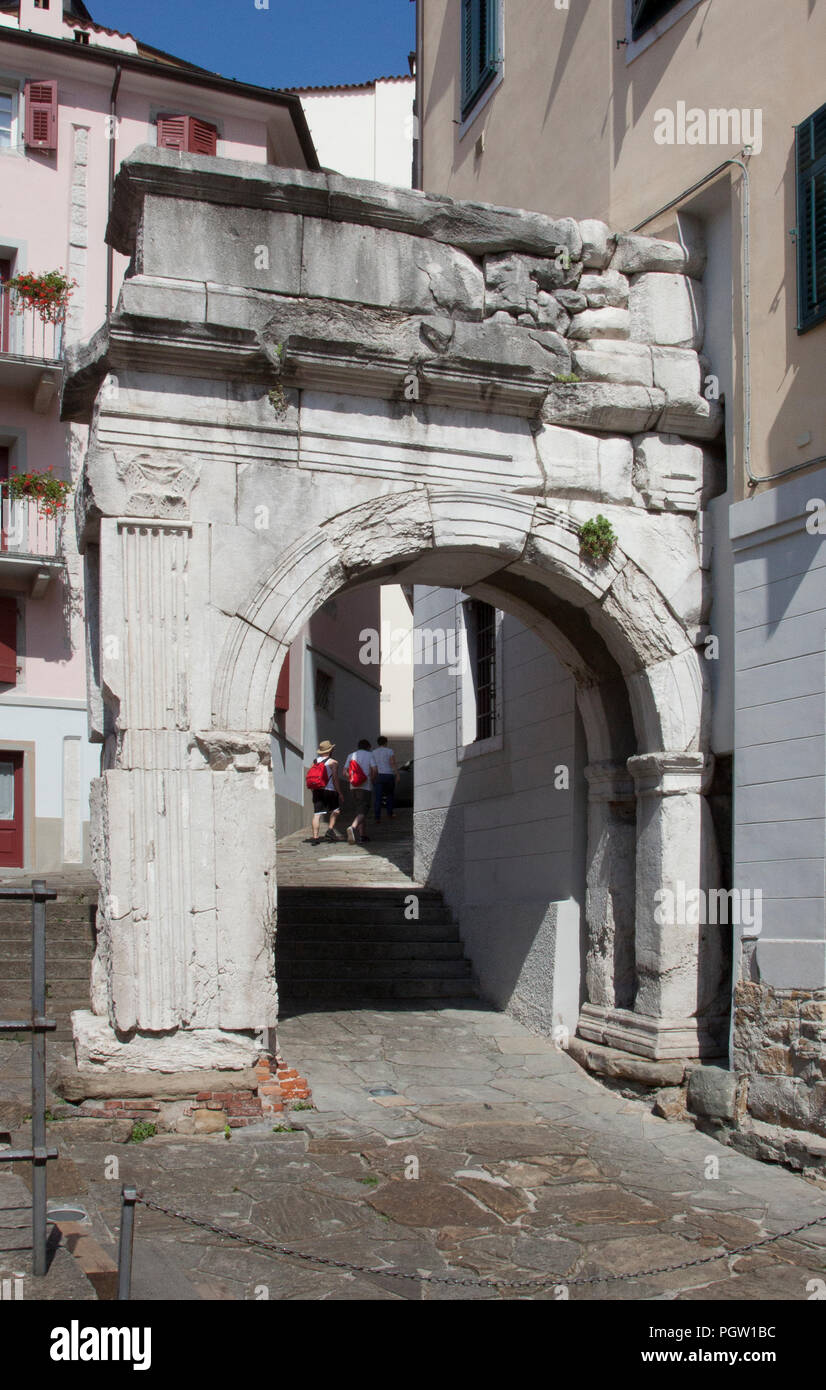 Tourists With Red Backpacks Follow An Ancient Path That Includes The Arco Di Riccardo Arch Of Richard In Trieste Italy Built By The Romans In Th Stock Photo Alamy