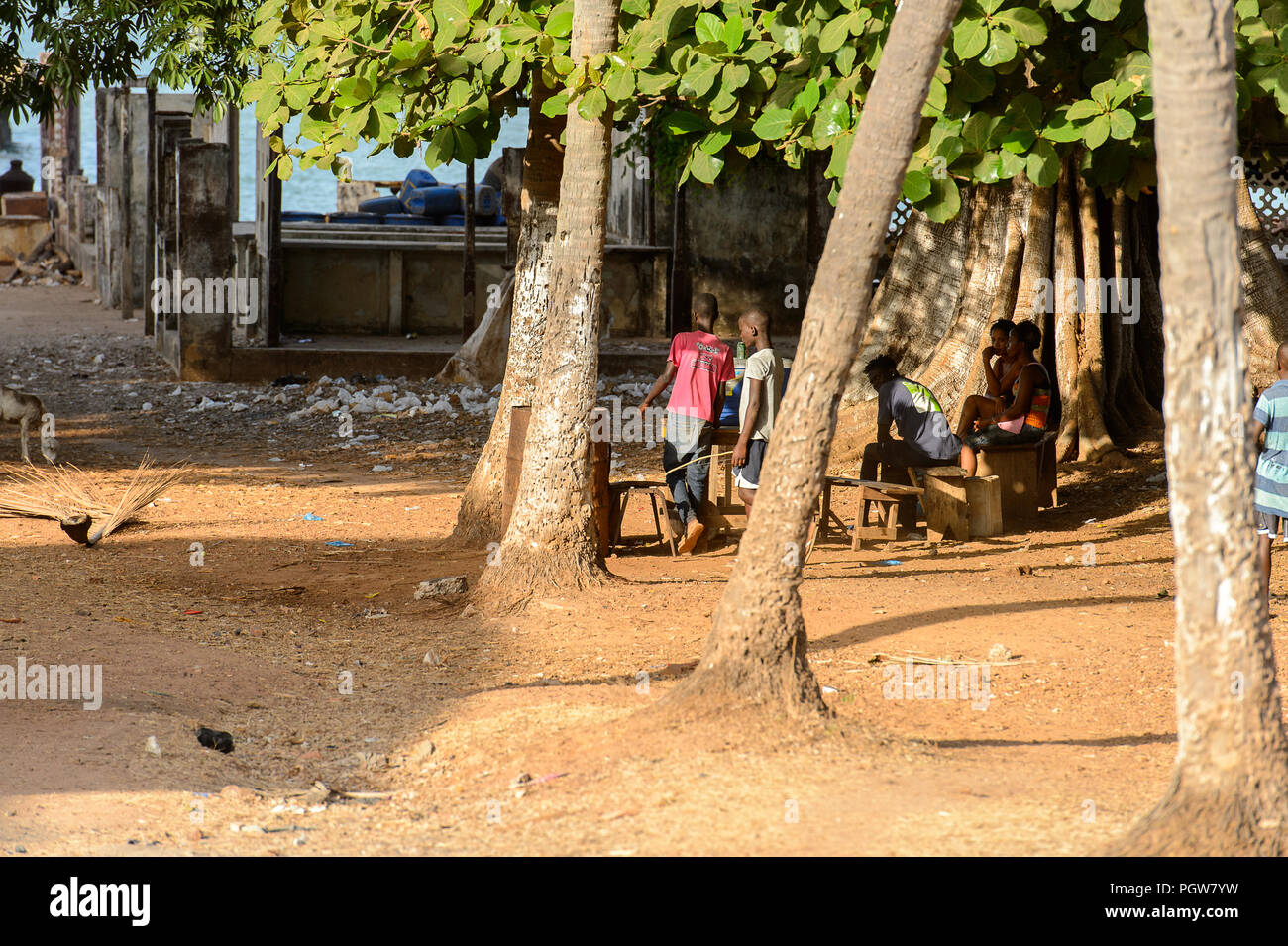 BOLAMA ISLAND, GUINEA BISSAU - MAY 6, 2017: Unidentified local people talk about something in the ghost town of Bolama, the former capital of Portugue Stock Photo