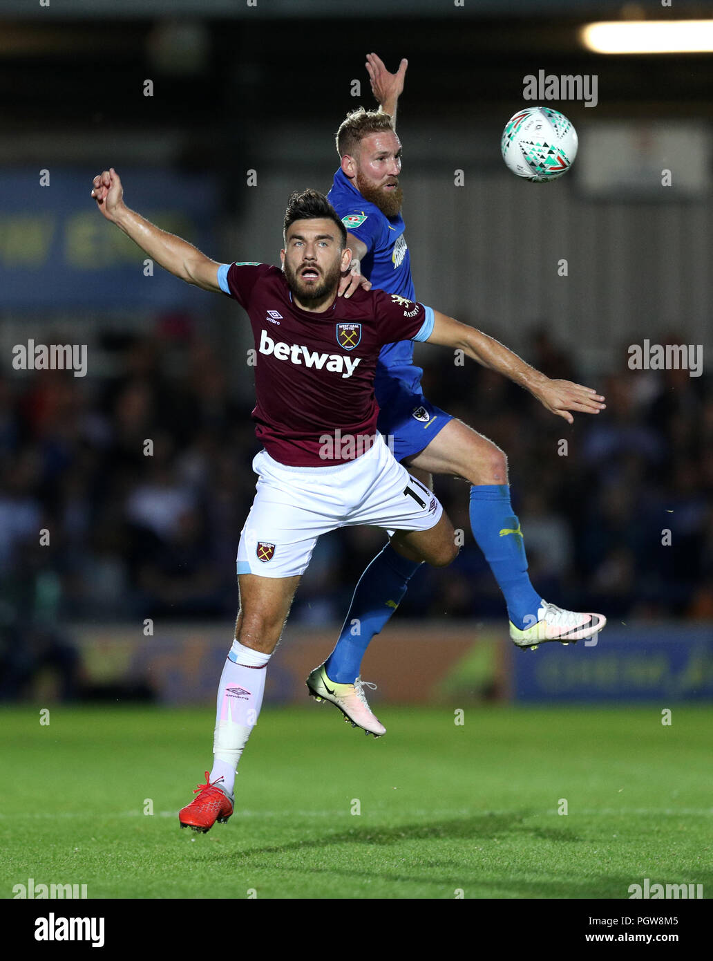 West Ham United's Robert Snodgrass and AFC Wimbledon's Scott Wagstaff battle for the ball during the Carabao Cup, second round match at Kingsmeadow, London. Stock Photo