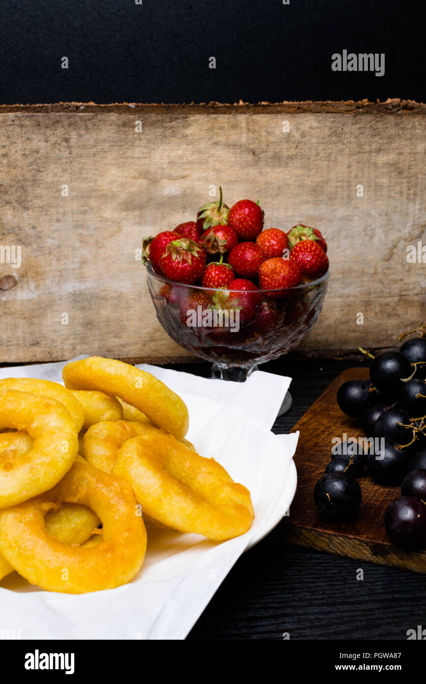 deep fried squid rings breaded with strawberry, grape on wooden