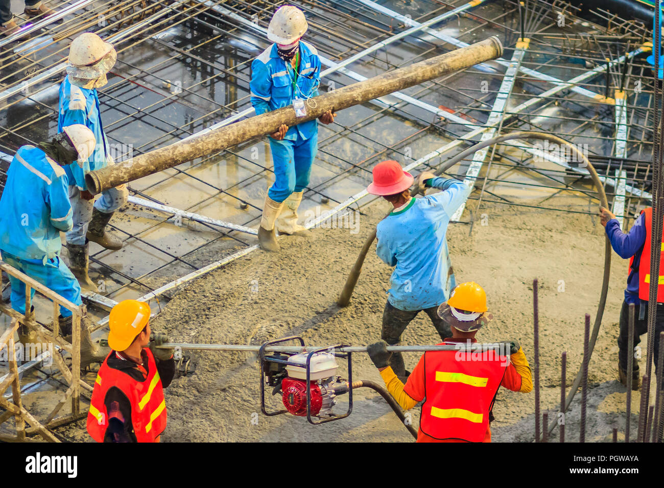 Construction Workers Using A Concrete Vibrator gasoline Engine Type 