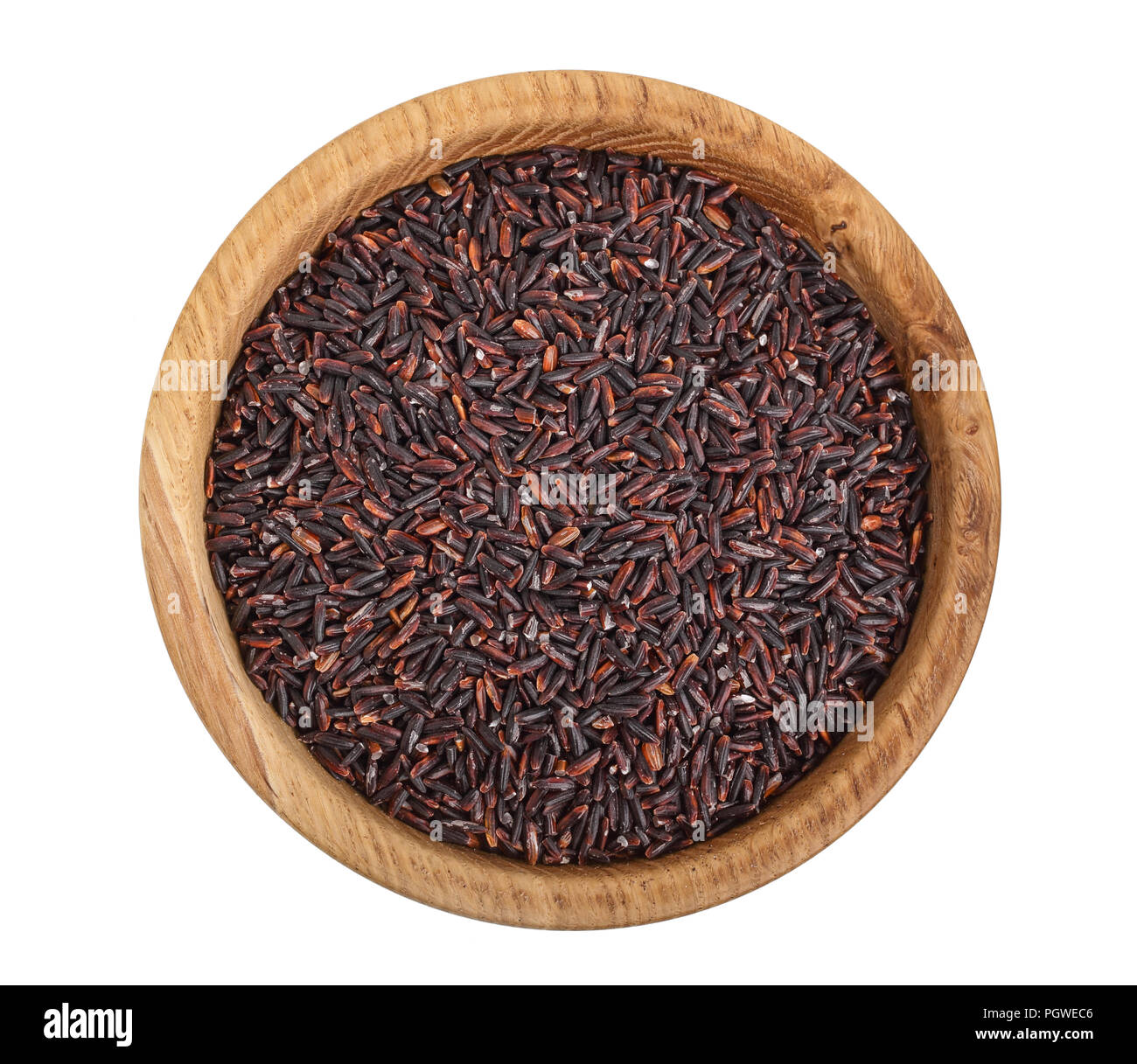 black rice grains in wooden bowl isolated on white background. Top view