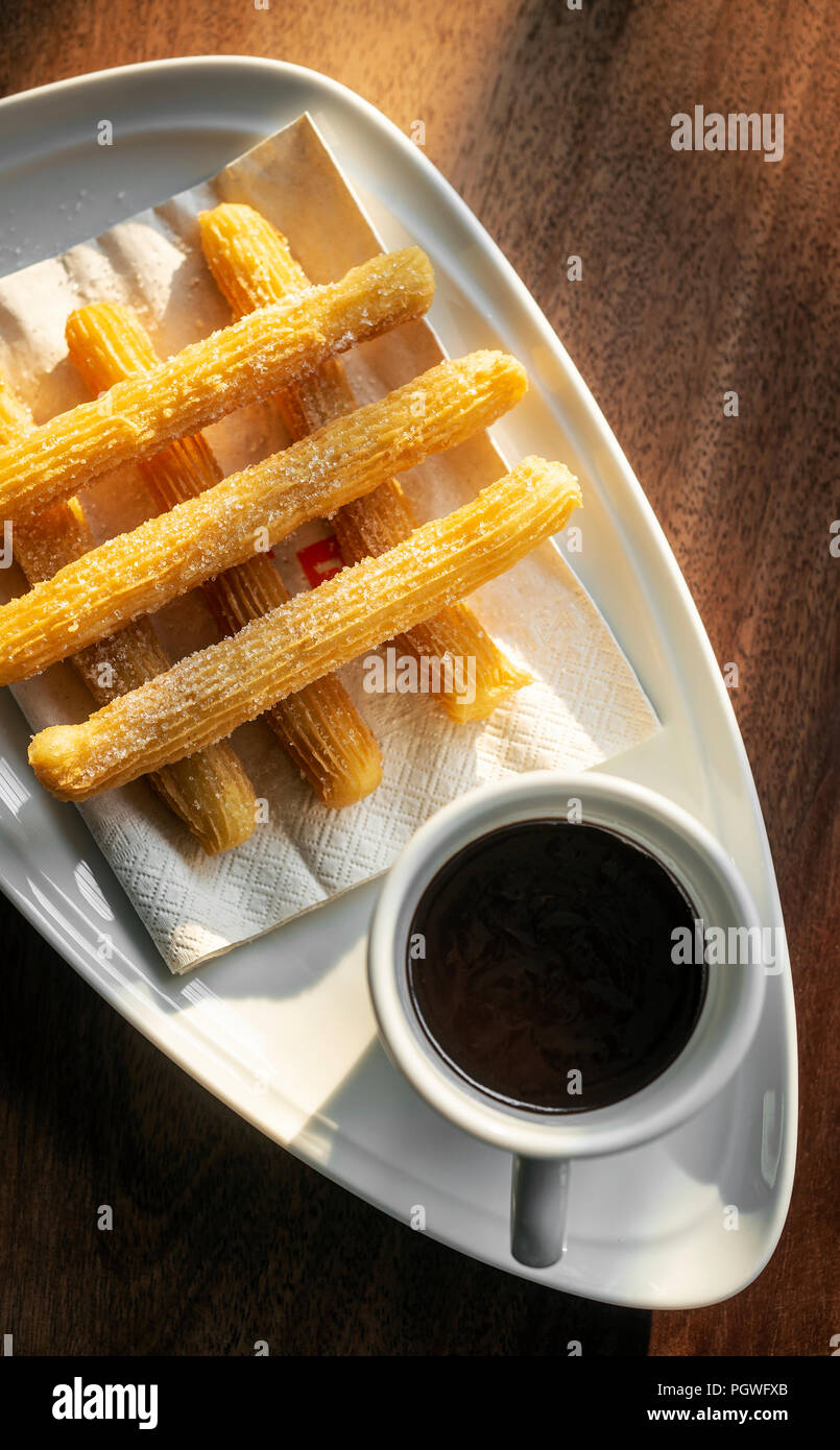 churros con chocolate traditional spanish sweet breakfast set on wooden table Stock Photo