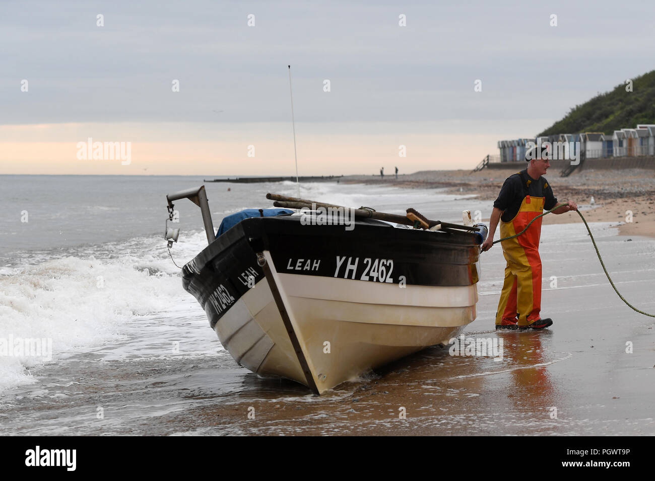 Crab fisherman John Lee with his boat on the beach at Cromer in Norfolk