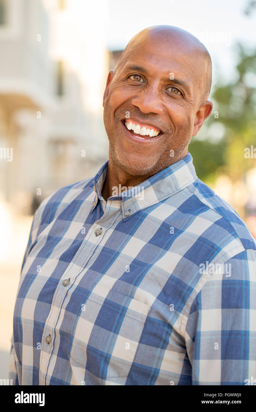 Happy mature African American man smiling outside. Stock Photo