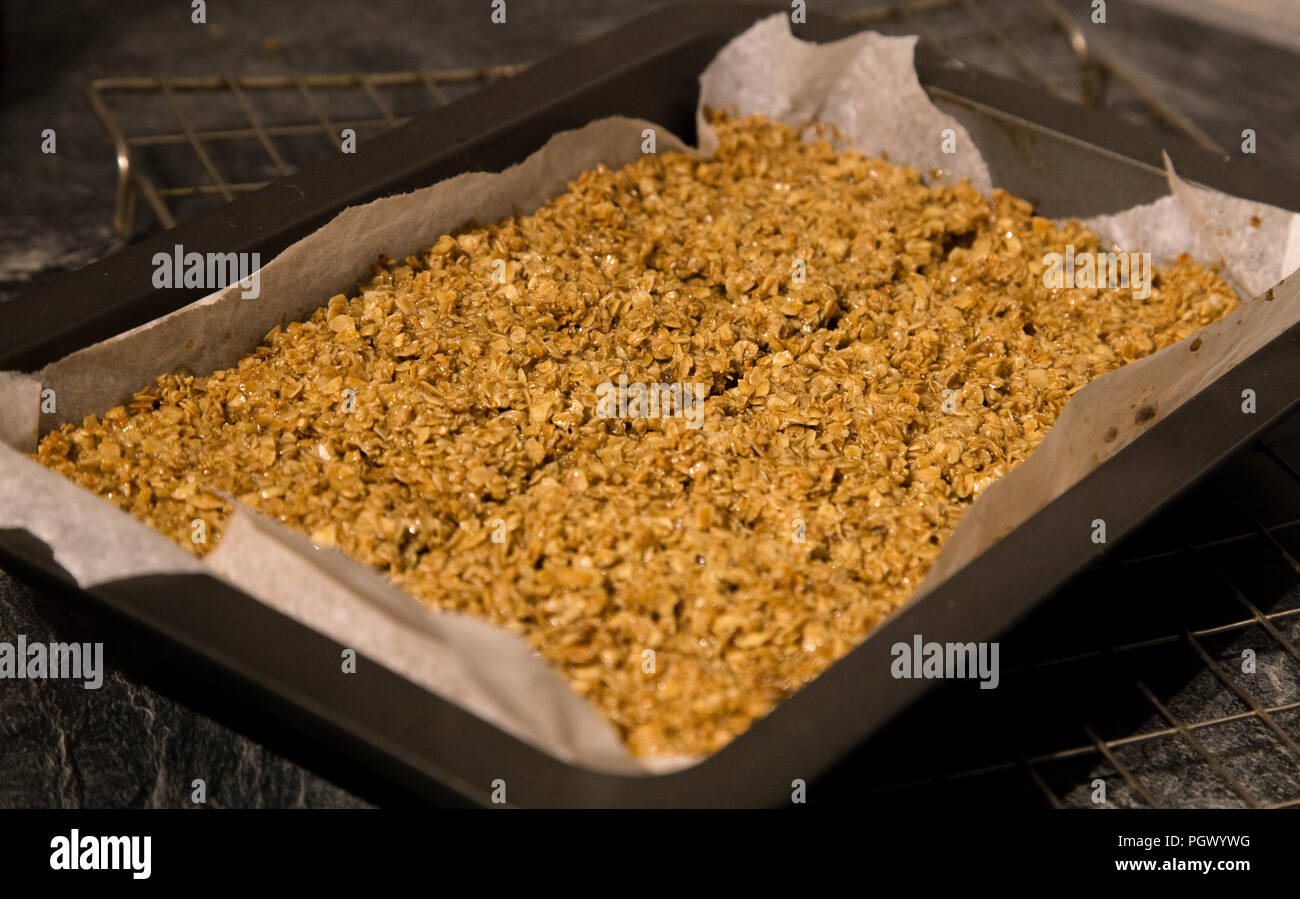 A tray of home baked flapjack just out of the oven. Stock Photo