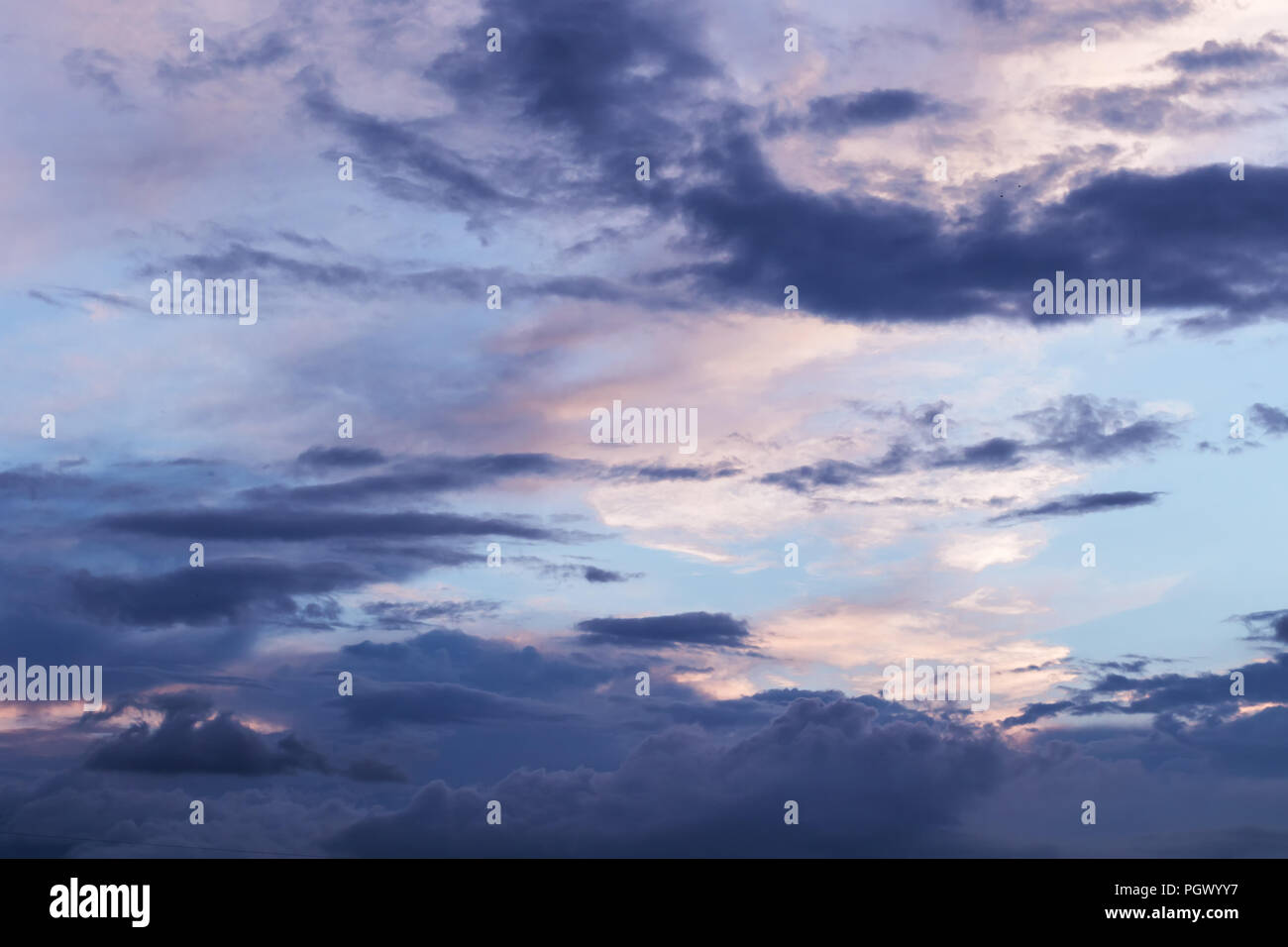 Evening sky with dramatic blueish clouds Stock Photo