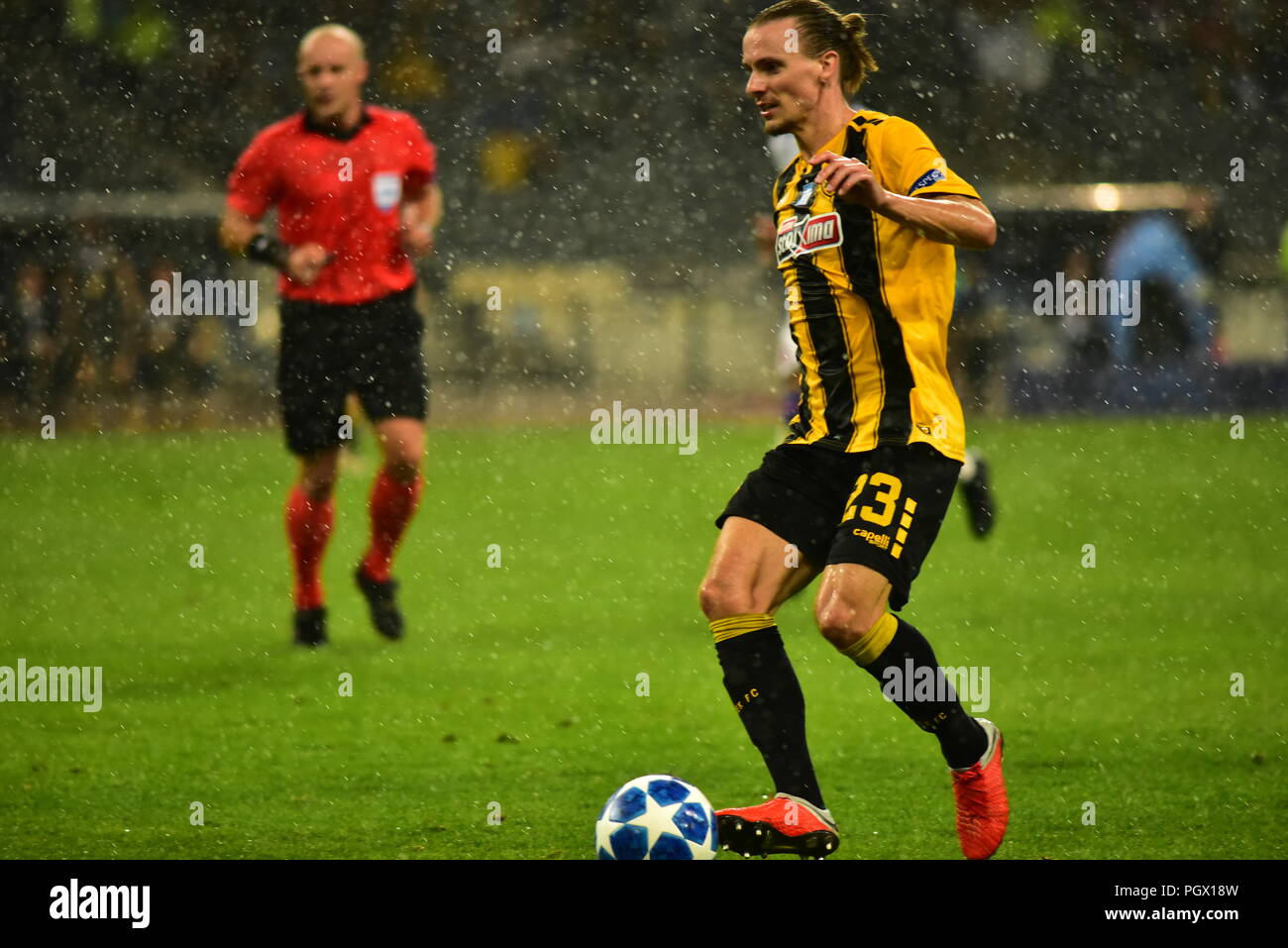 Athens, Greece. 28th Aug, 2018. Niklas Hult (no 23) of AEK manage to  control the ball, despite the heavy rain. Credit: Dimitrios  Karvountzis/Pacific Press/Alamy Live News Stock Photo - Alamy