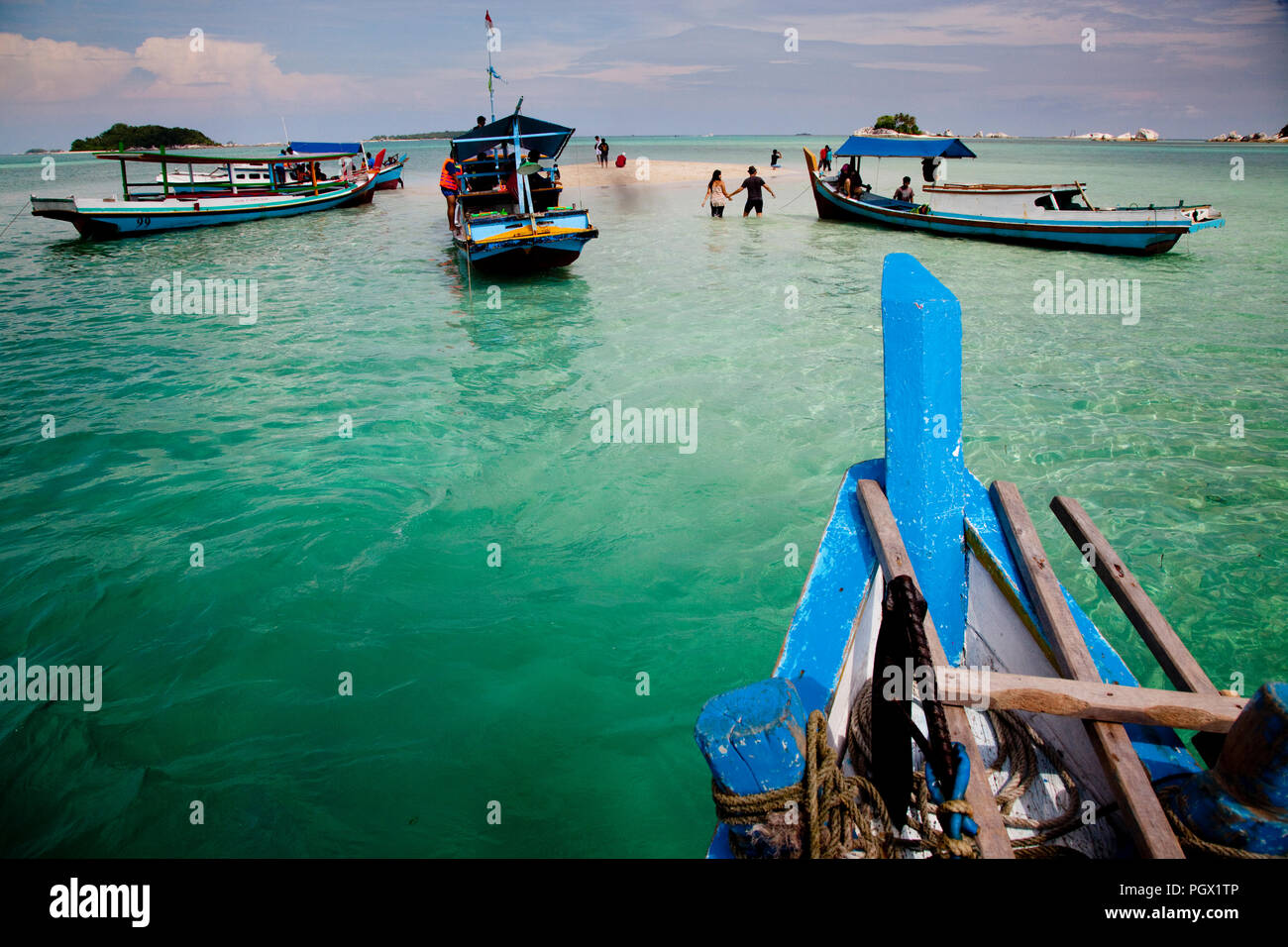 A couple visits a picturesque sand island off the coast of Belitung, Indonesia. Stock Photo