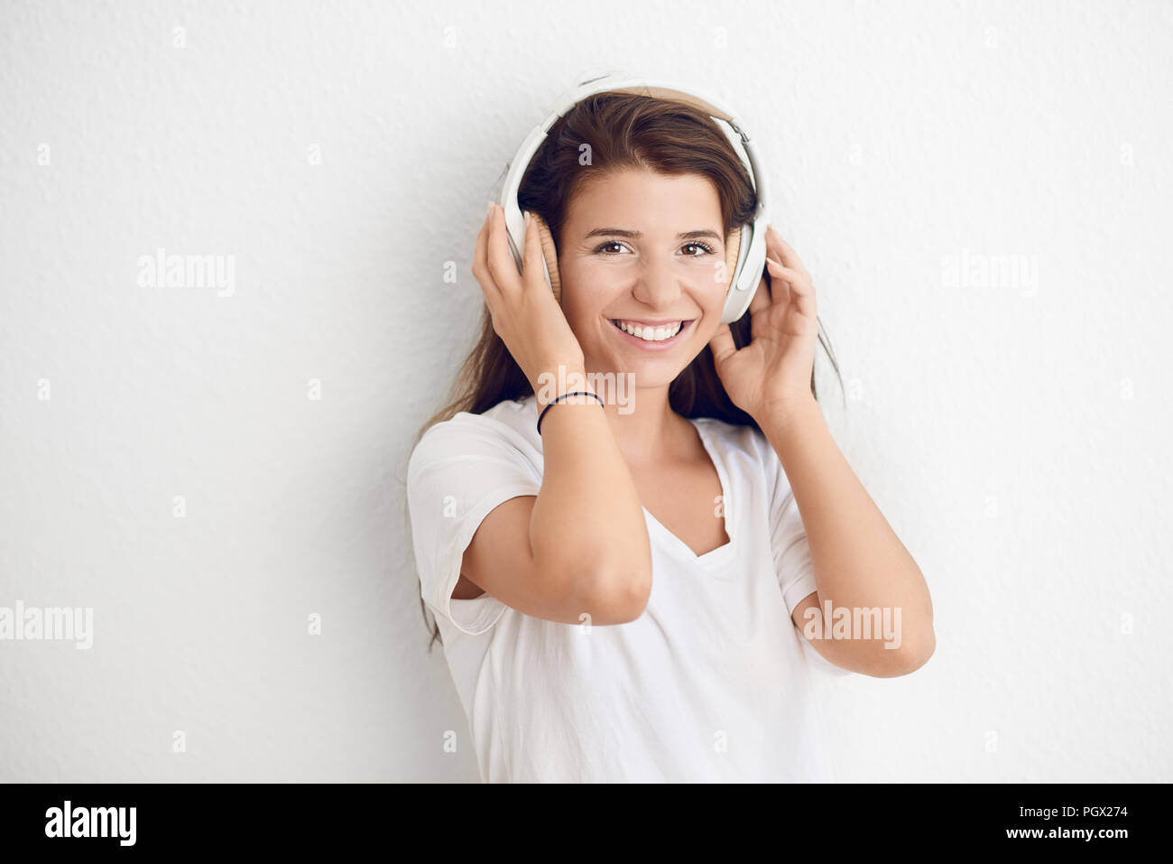 Woman Laughing against wall Stock Photo - Alamy