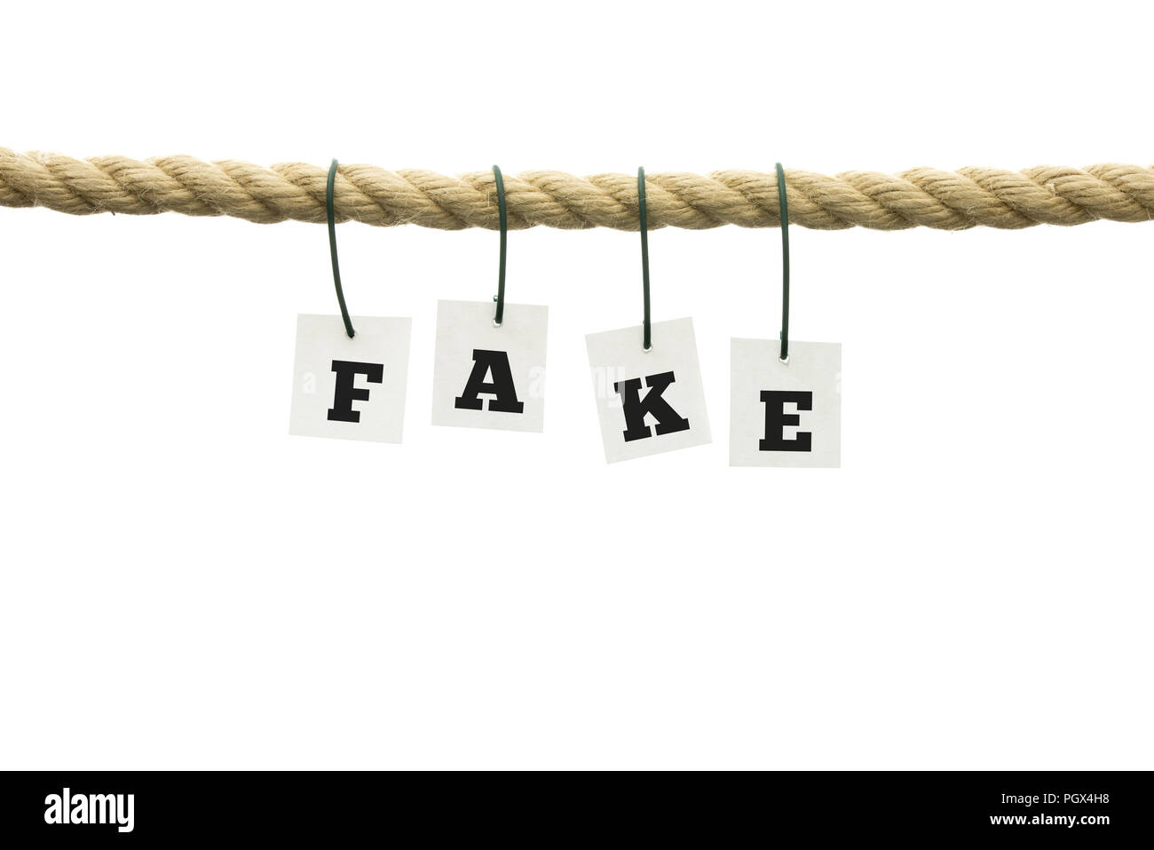 Word - Fake - suspended from a rope with each individual letter attached by a wire conceptual of something that is neither authentic nor genuine, over Stock Photo
