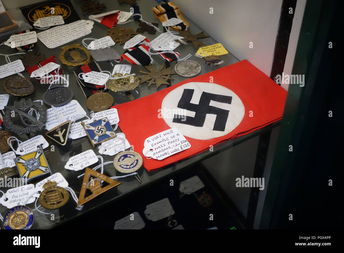 German Nazi Party Swastika armband and military medals and items of  Bric-à-brac on display an English Antiques centre Stock Photo - Alamy