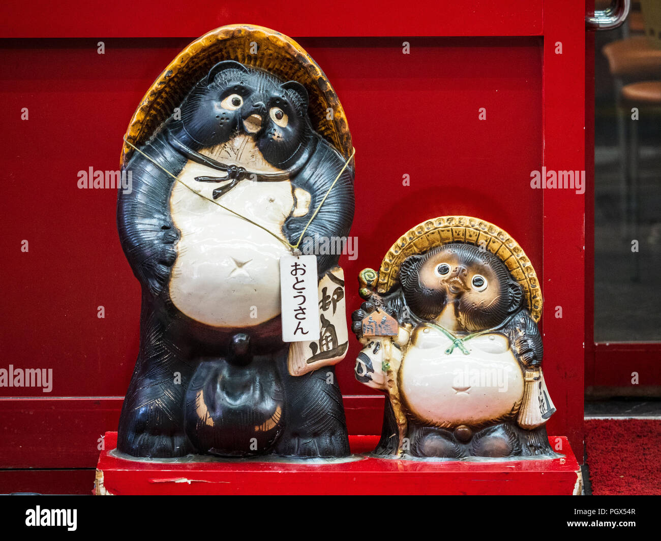Japanese Raccoon Dog statue in Hokkaido - also known as Tanuki or mangut the statues of the Raccoon Dogs are meant to bring good fortune in Japan. Stock Photo