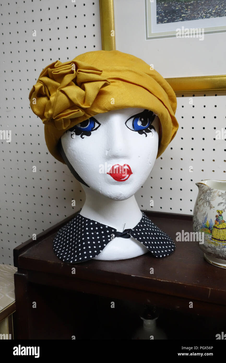 Mannequin Head wearing yellow hat on display an English Antiques centre Stock Photo