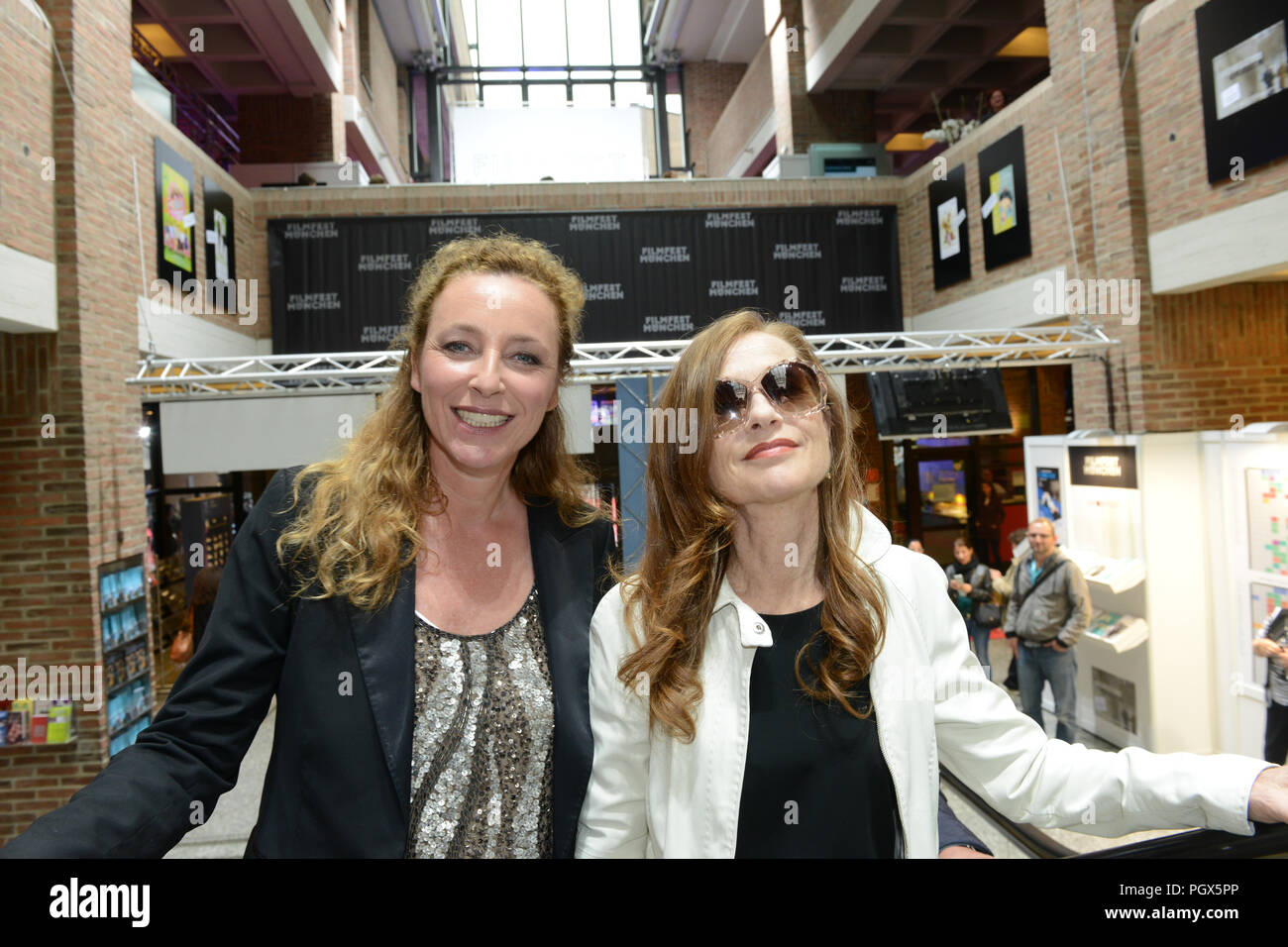 Actress Isabelle Huppert arrives at Filmfest München 2014 with festival director Diana Iljine Stock Photo