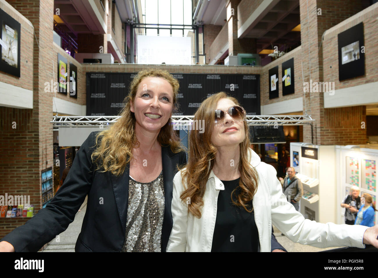 Actress Isabelle Huppert arrives at Filmfest München 2014 with festival director Diana Iljine Stock Photo