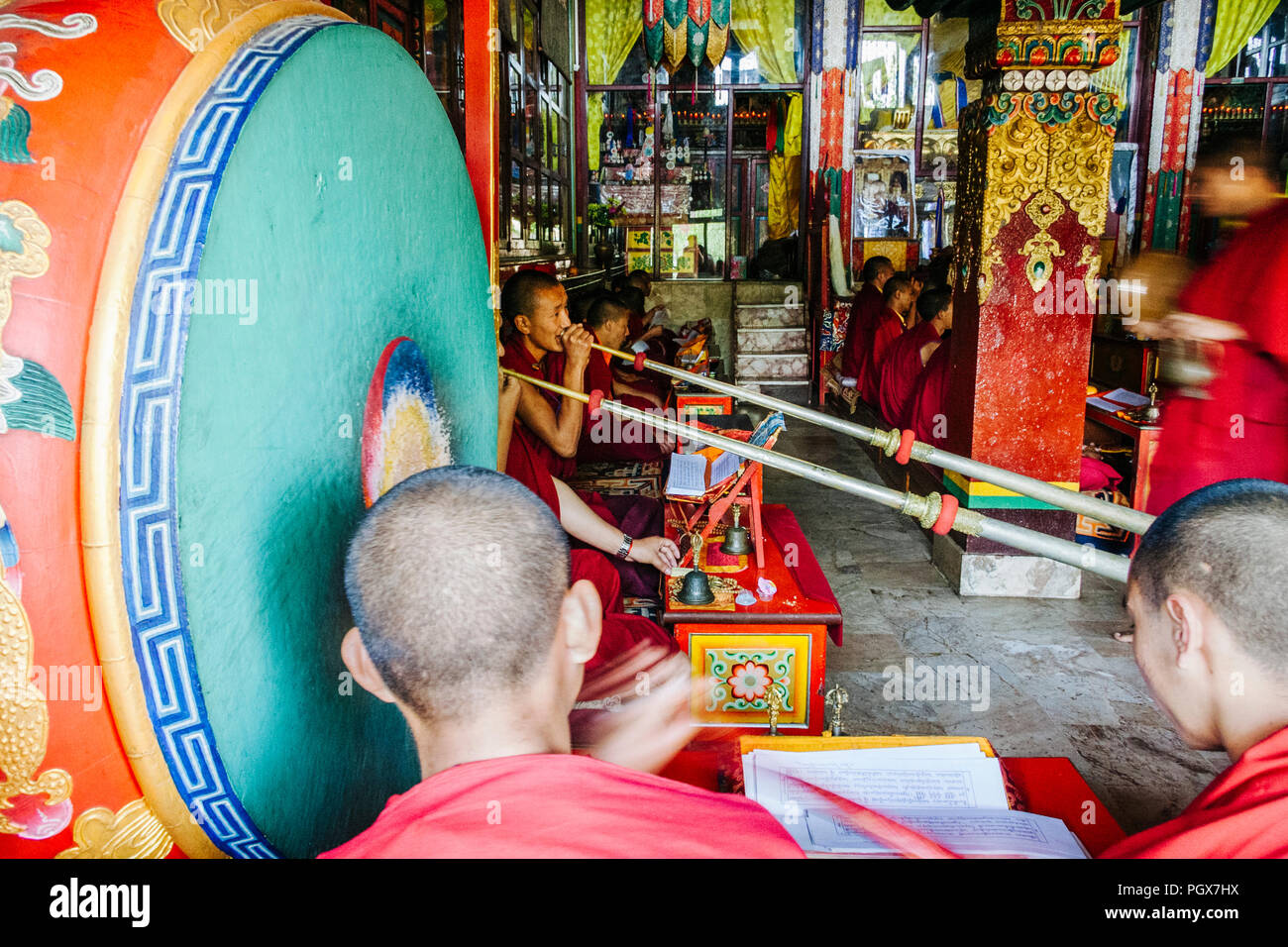 Bodhnath , Kathmandu, Bagmati, Nepal : Buddhist monks pray and play musical instruments inside one of over 50 gompas (Buddhist monastery) built around Stock Photo
