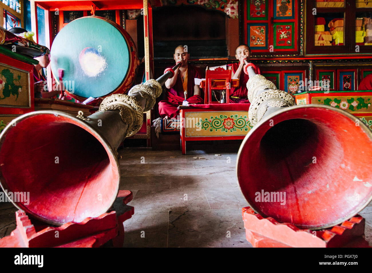 Bodhnath , Kathmandu, Bagmati, Nepal : Buddhist monks pray and play musical instruments inside one of over 50 gompas (Buddhist monastery) built around Stock Photo