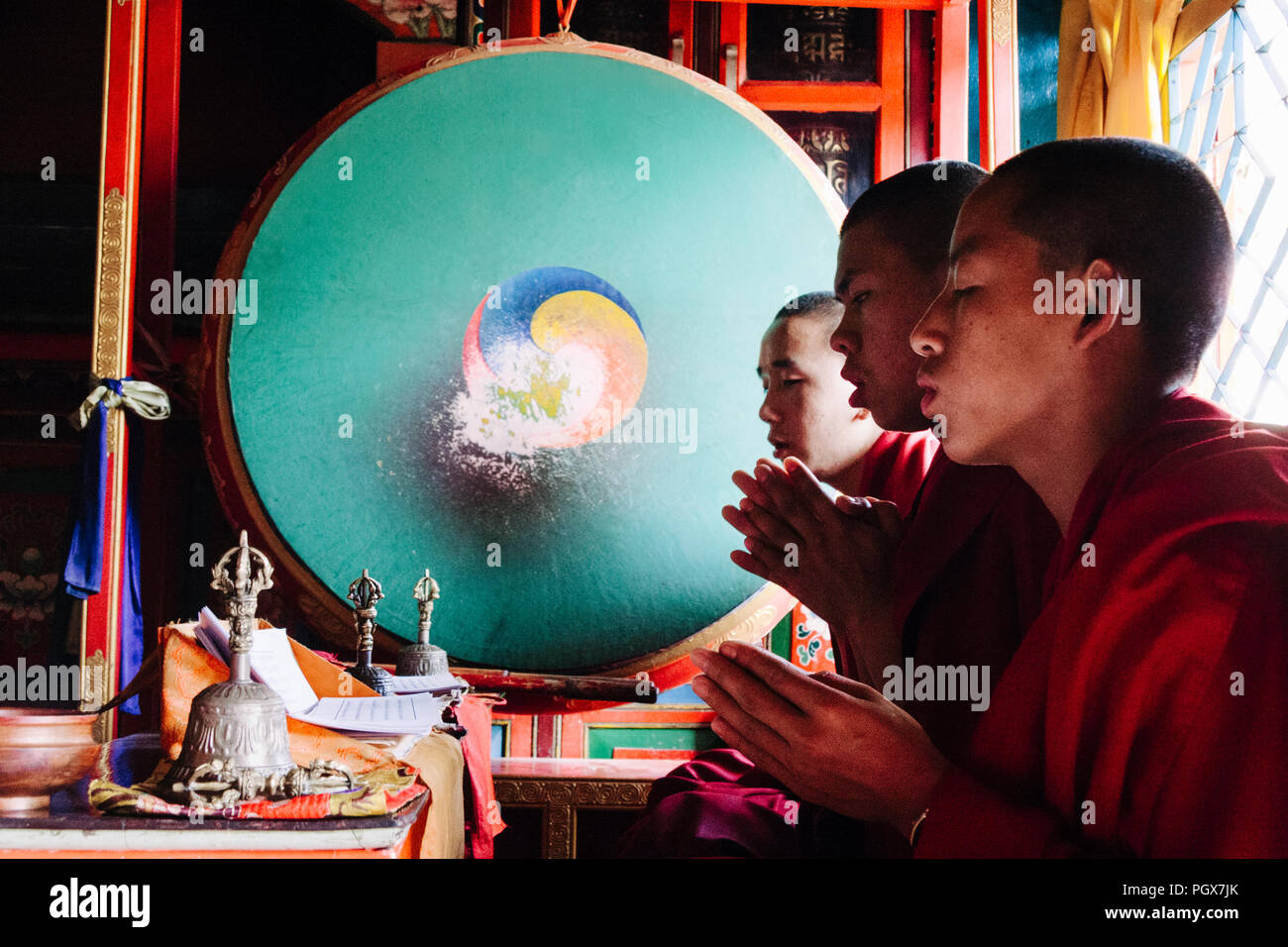 Bodhnath , Kathmandu, Bagmati, Nepal : Buddhist monks pray inside one of over 50 gompas (Buddhist monastery) built around Bodhnath due to the influx o Stock Photo