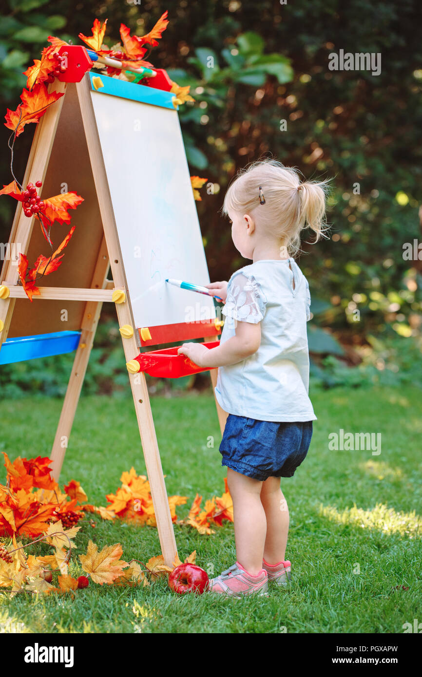 White Caucasian toddler child kid girl standing outside in summer
