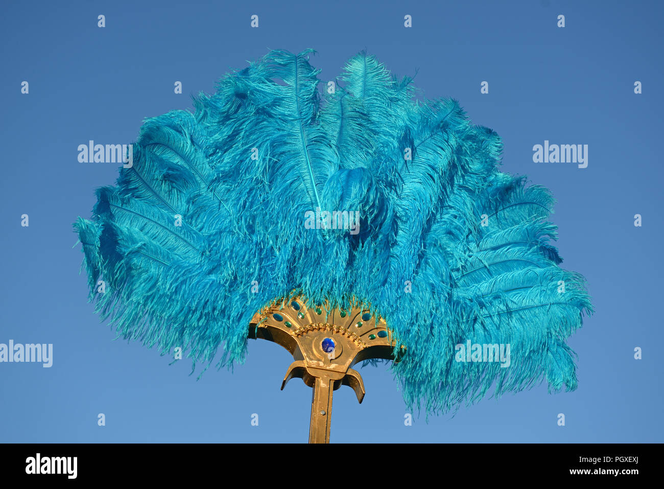 A blue ostrich feather fan stands out against a blue sky Stock Photo