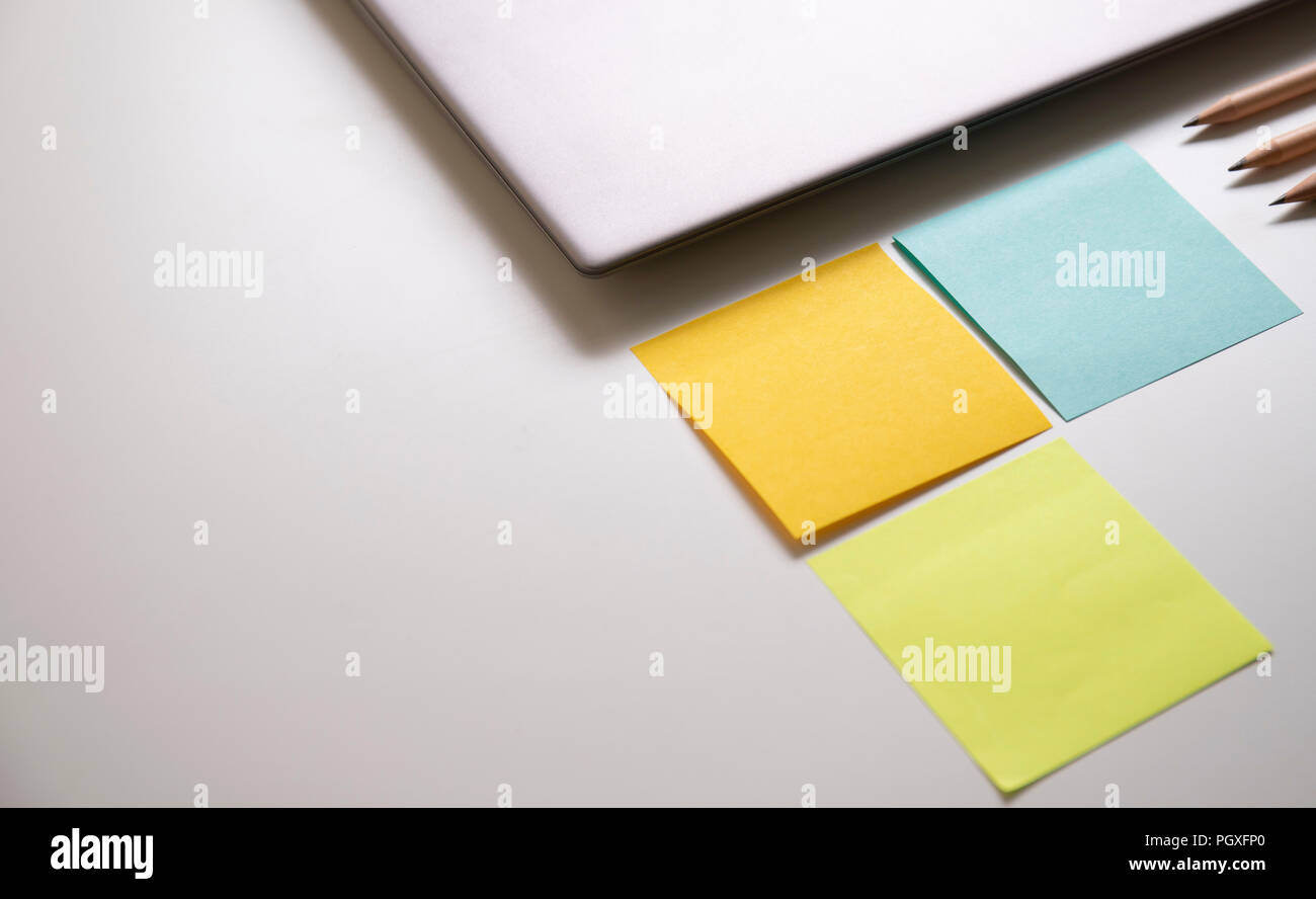 workplace with laptop computer and office supply on the white table in