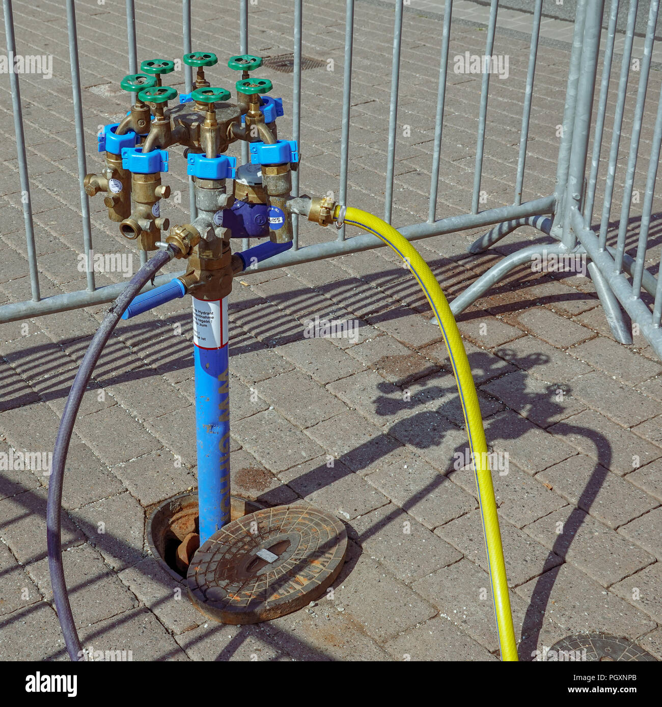 Standpipe on a hydrant for the water supply of the travelling traders at a street festival. Stock Photo