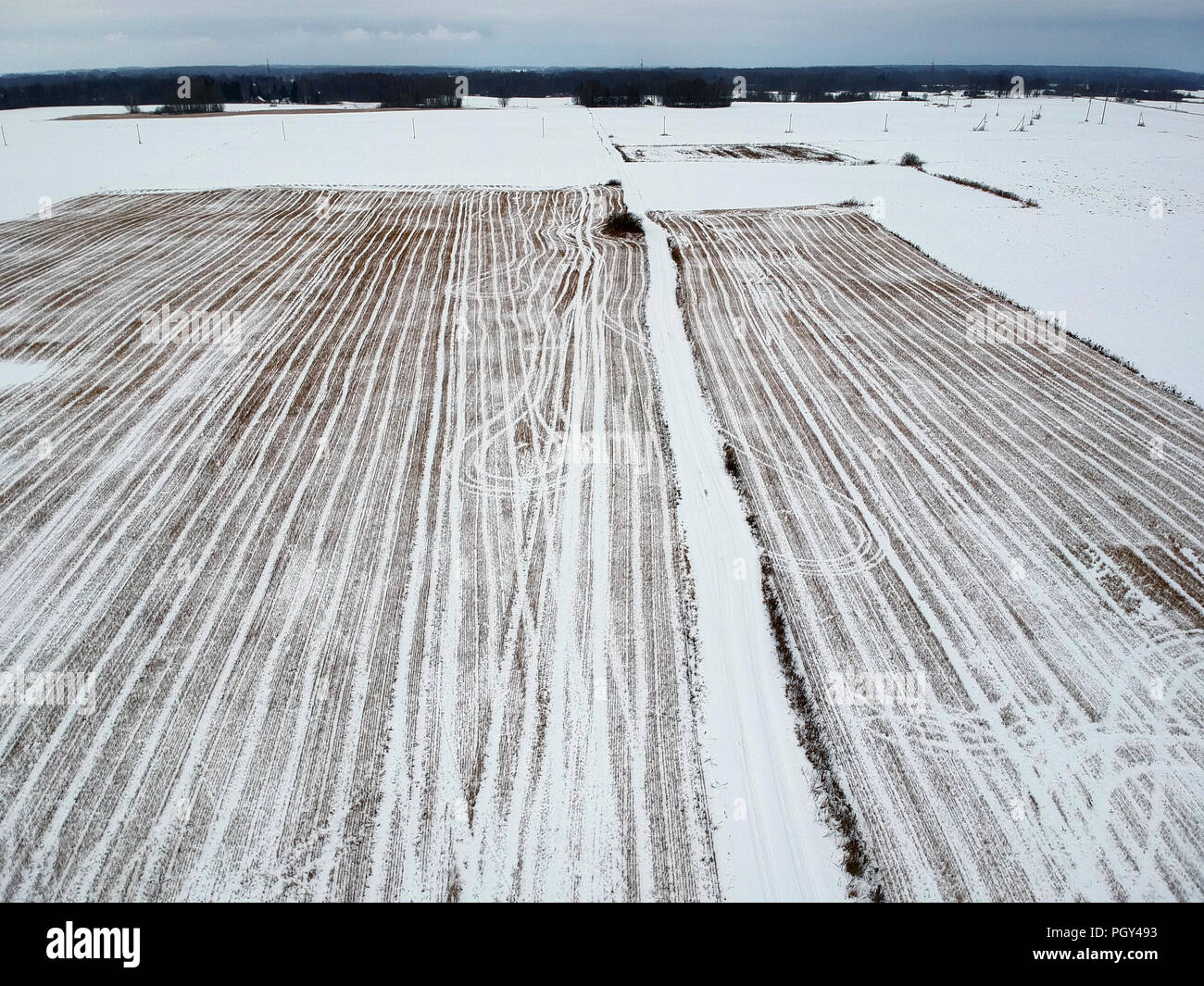 winter time fallow  stubble agriculture field with snow, aerial view Stock Photo