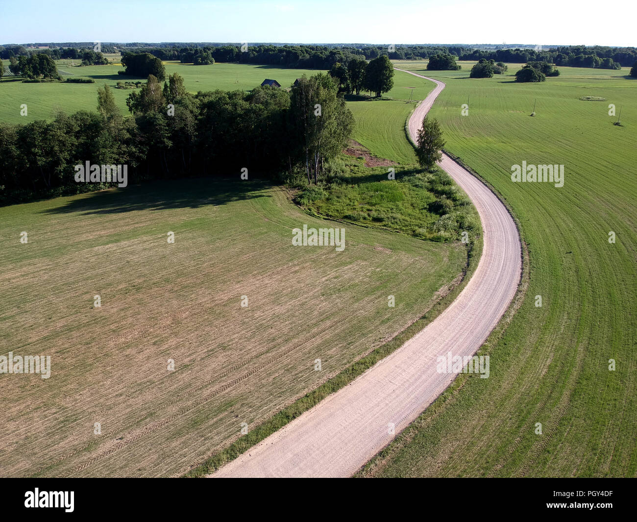 farmland landscape wirh white gravel road in spring, aerial view Stock Photo