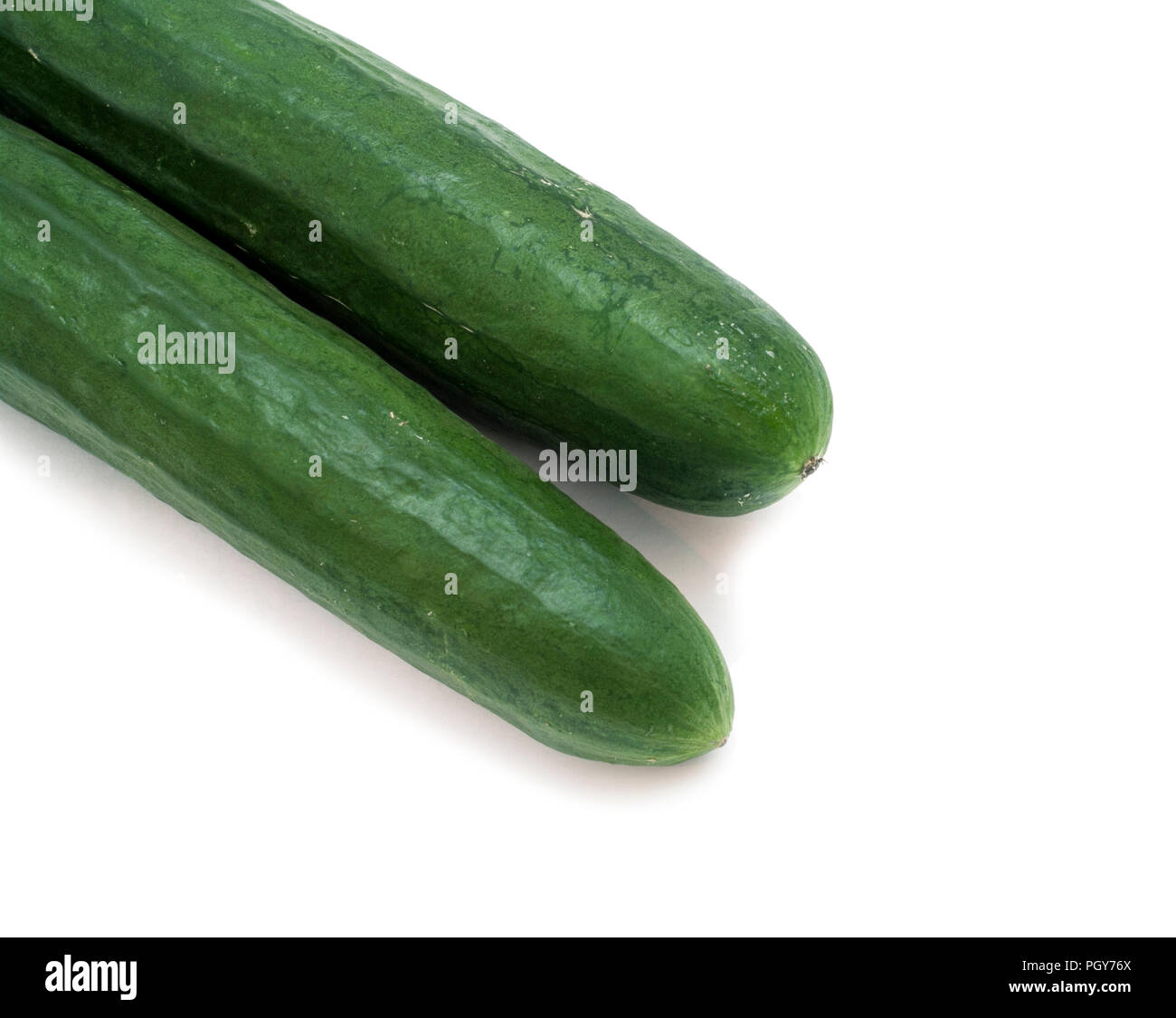 Two green cucumbers on isolated white background Stock Photo