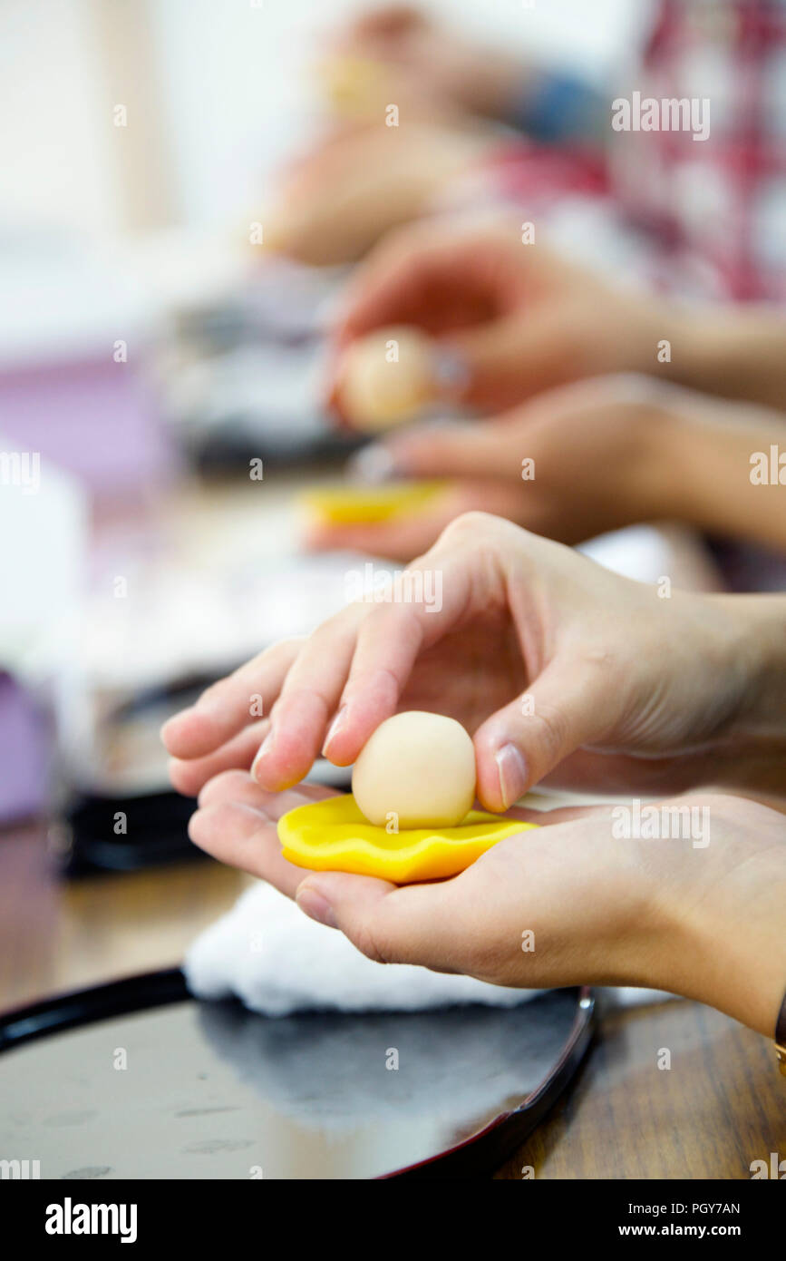 Visitors try their hand at making Kyoto wagashi sweets during a class