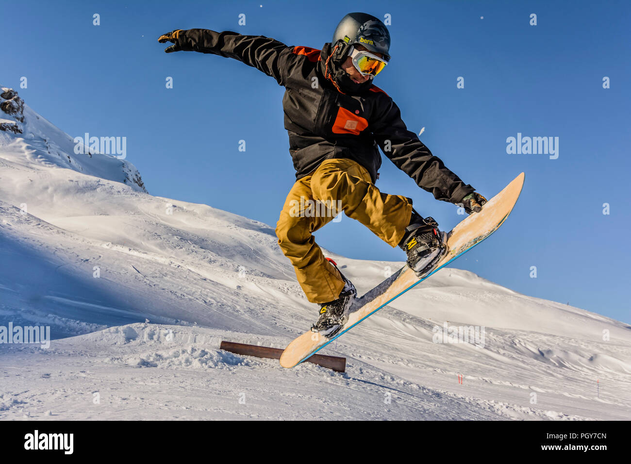 A freestyle snowboarder makes a backside air grab Stock Photo Alamy