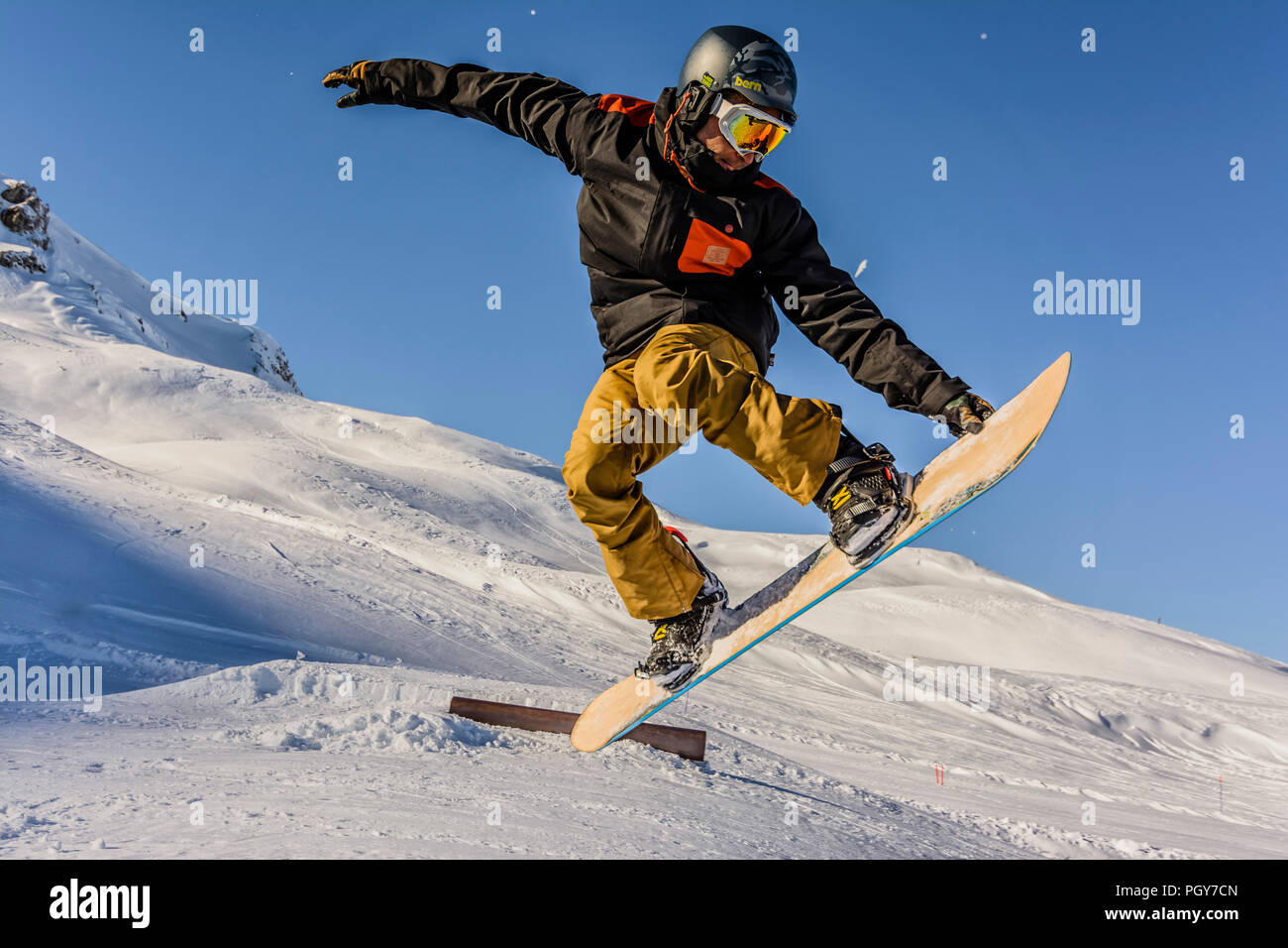 A freestyle snowboarder makes a backside air grab Stock Photo - Alamy