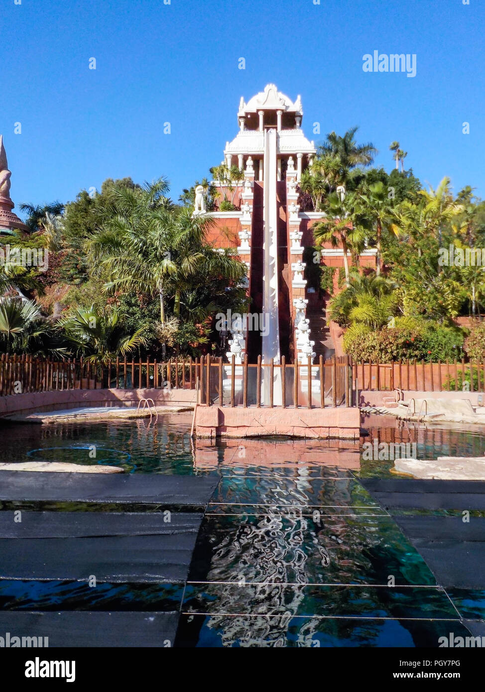 ADEJE, TENERIFE, SPAIN-CIRCA JAN, 2016: Visitors slide from water slide  into pool. Tower of power is a slide of 28 m high where speed of up to 80km/ h Stock Photo - Alamy
