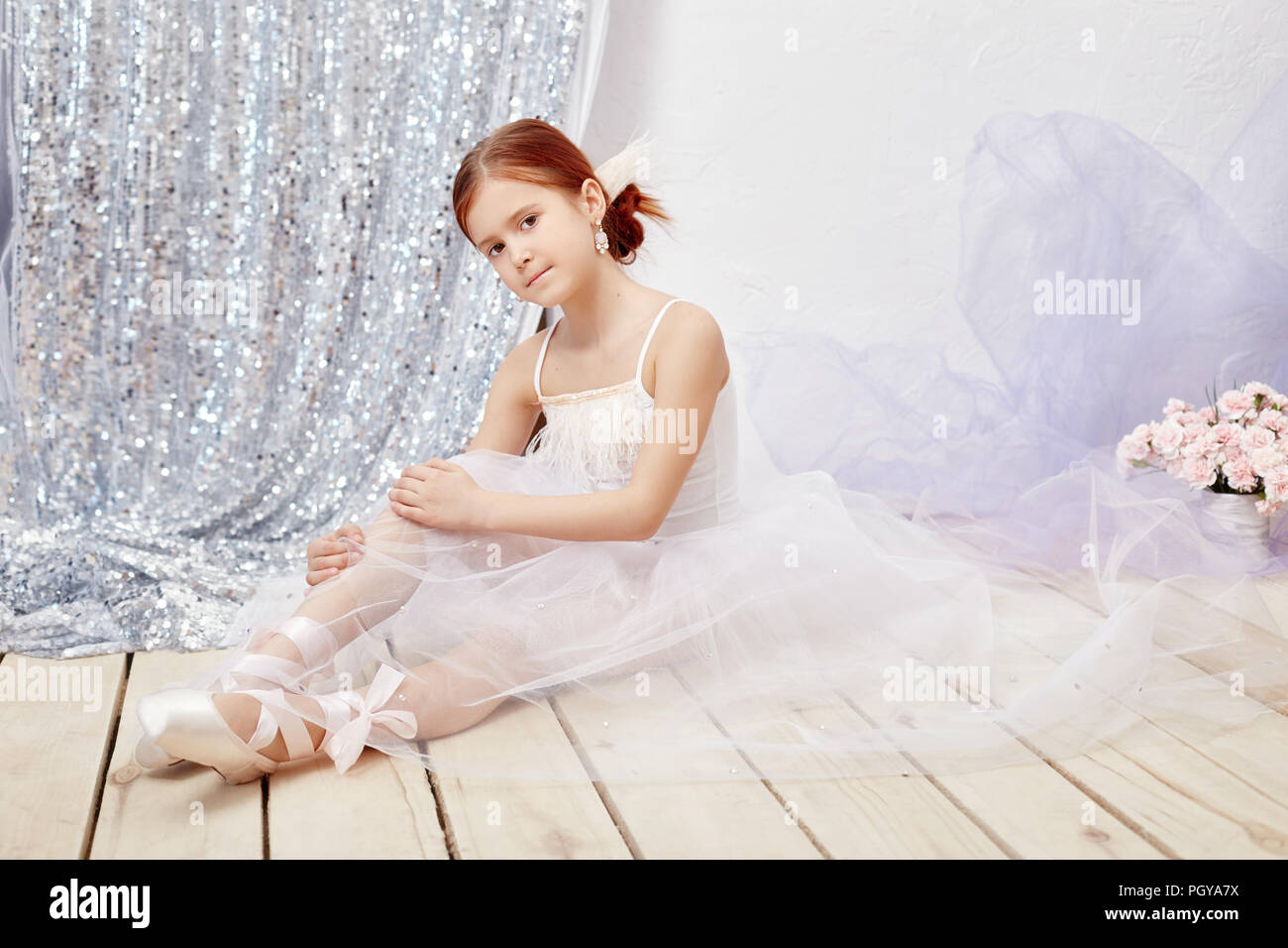 Little prima ballet. Young ballerina girl is preparing for a ballet ...