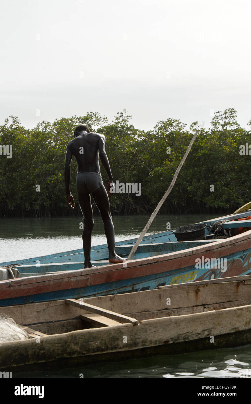 RUBANE, GUINEA BISSAU - MAY 4, 2017: Unidentified local boy stands in the  boat Stock Photo - Alamy