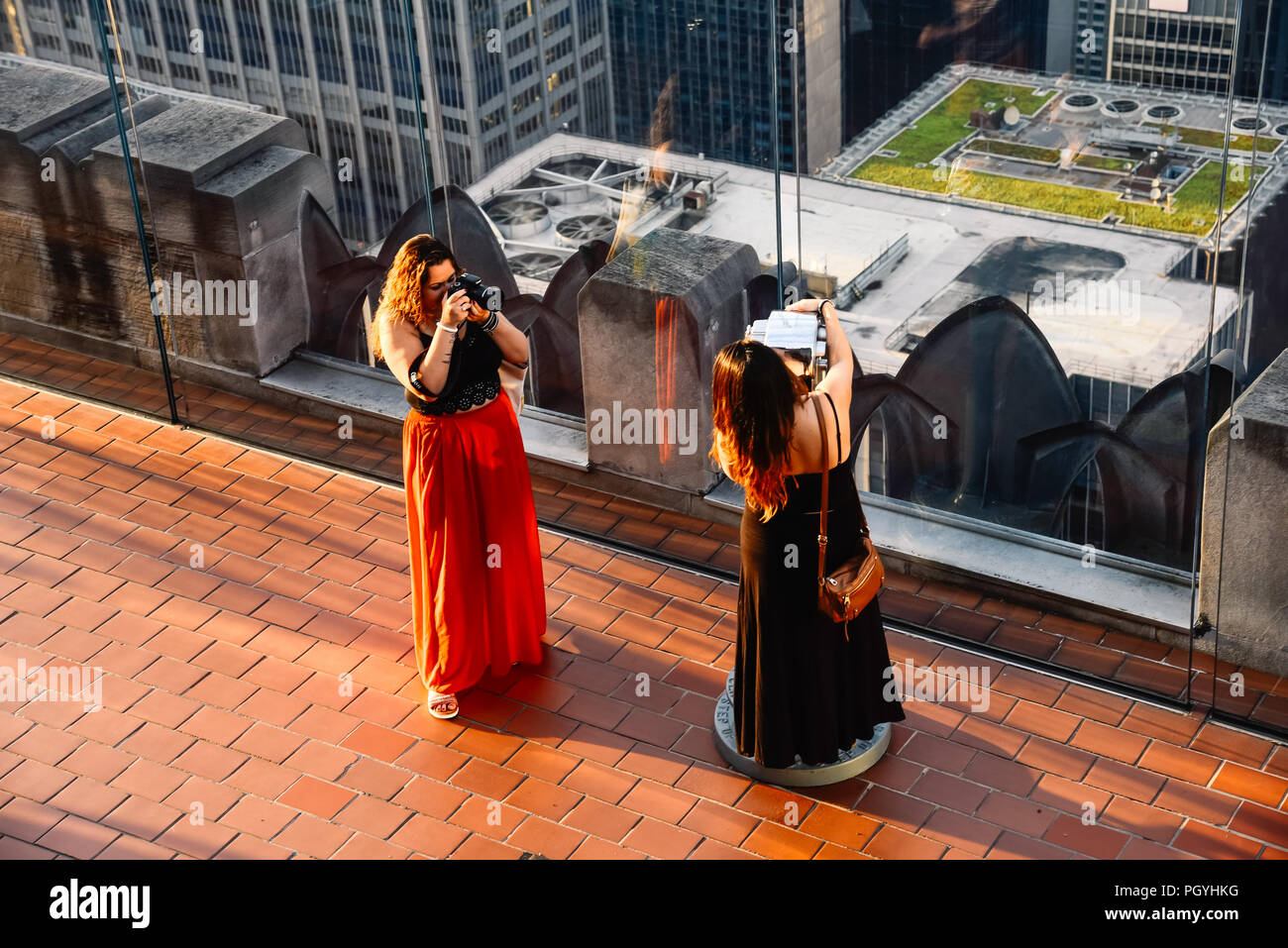 New York City, USA - June 21, 2018: Female tourists taking photos at Top of the Rock observation deck Stock Photo