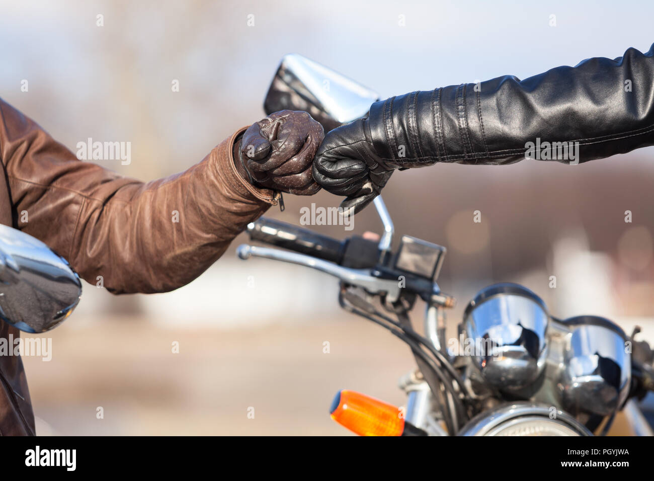 Close up of bikers hands in leather gloves with repay a salutation