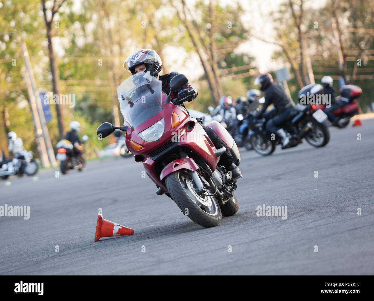 Track with laying cones for motorcyclists on city outskirts, rider on asphalt square Stock Photo
