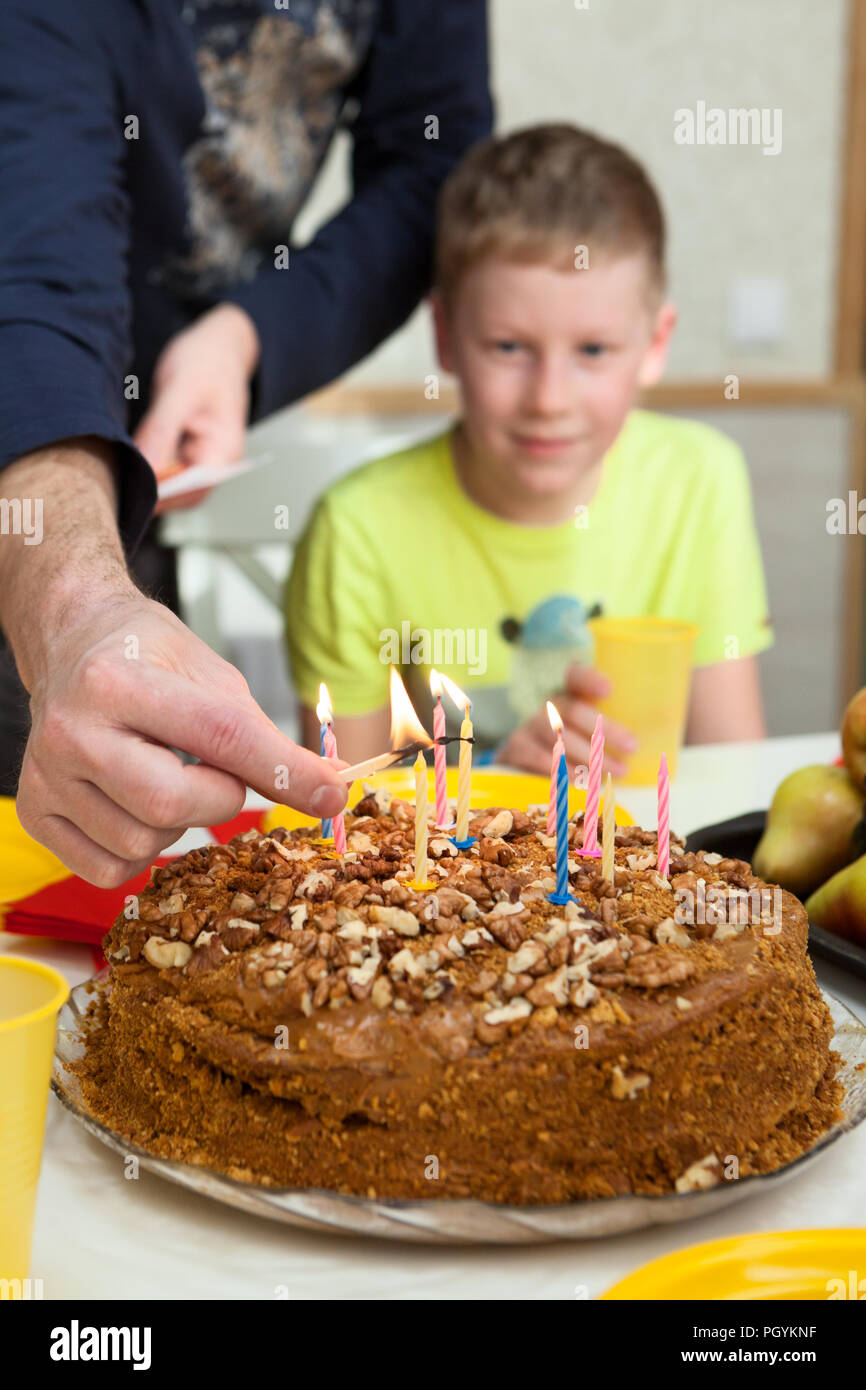 Happy boy celebrating his birthday and ready to blow candles on