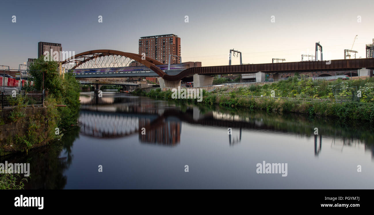 A Northern Rail train crosses the River Irwell between Manchester and Salford on the newly constructed Ordsall Chord railway, part of the 'Northern Po Stock Photo