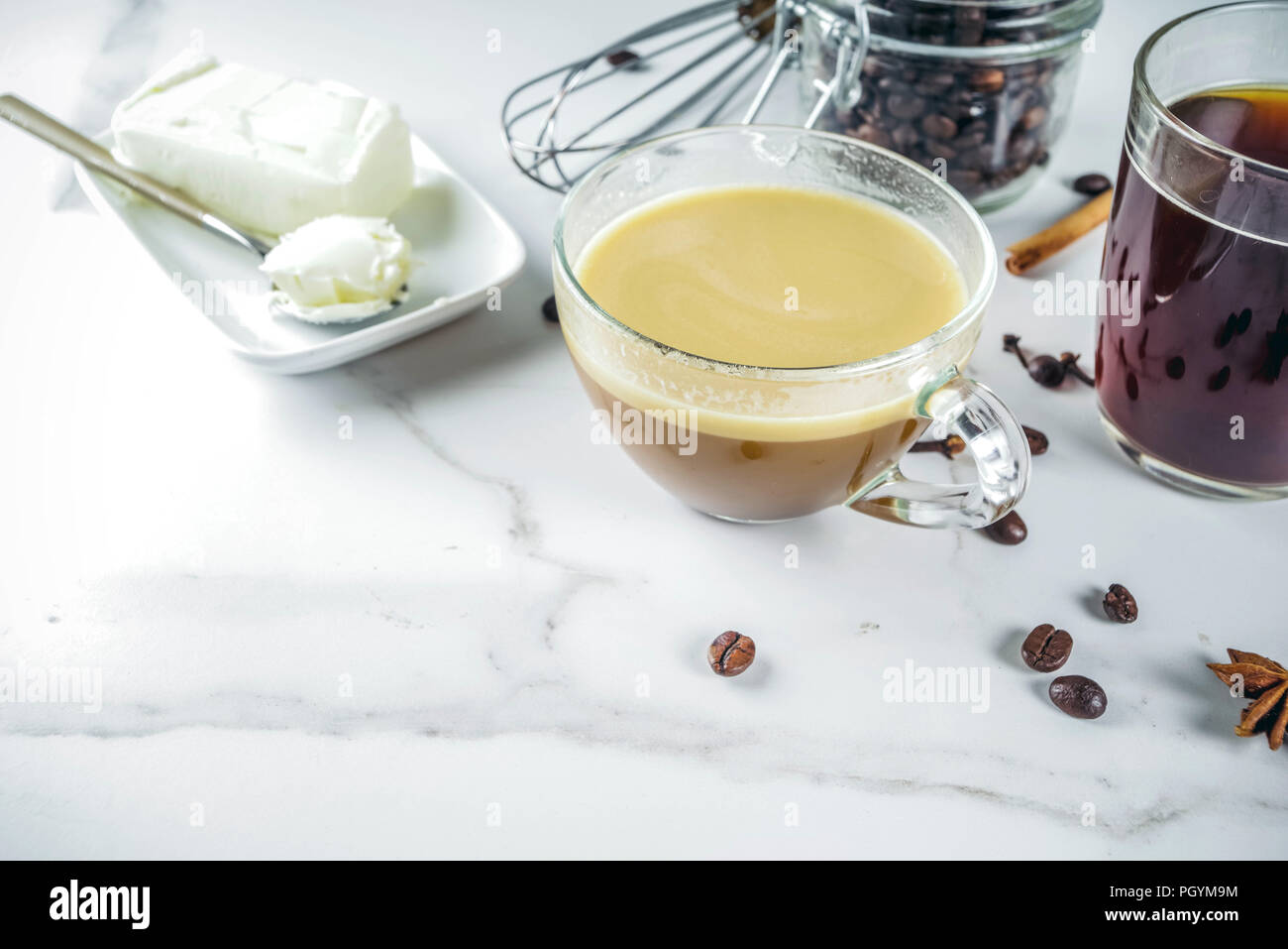 Trendy ketogenic diet food, Bulletproof coffee with milk and butter, white marble background copy space Stock Photo
