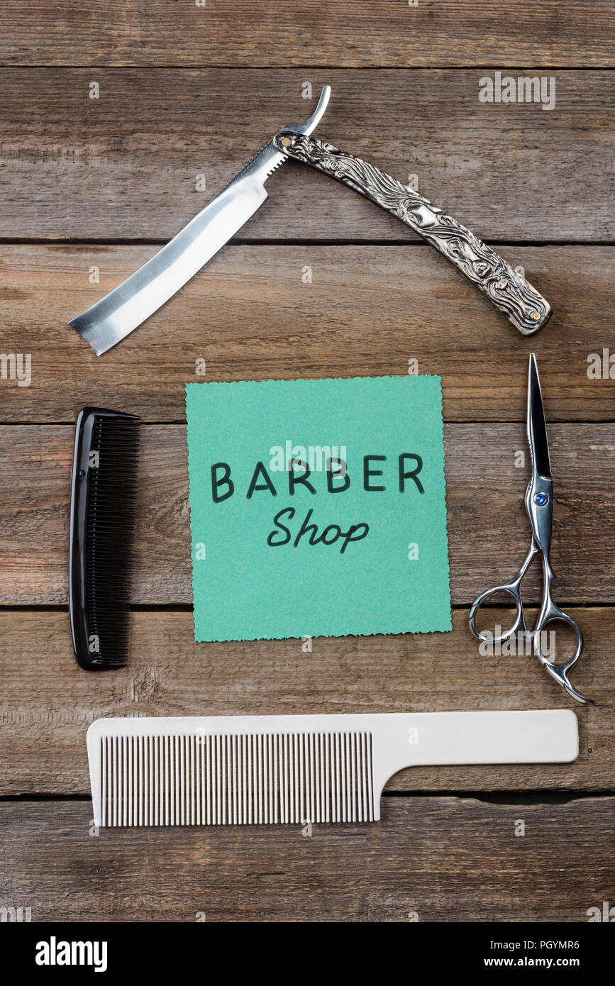 Barbershop sign on wooden background Stock Photo