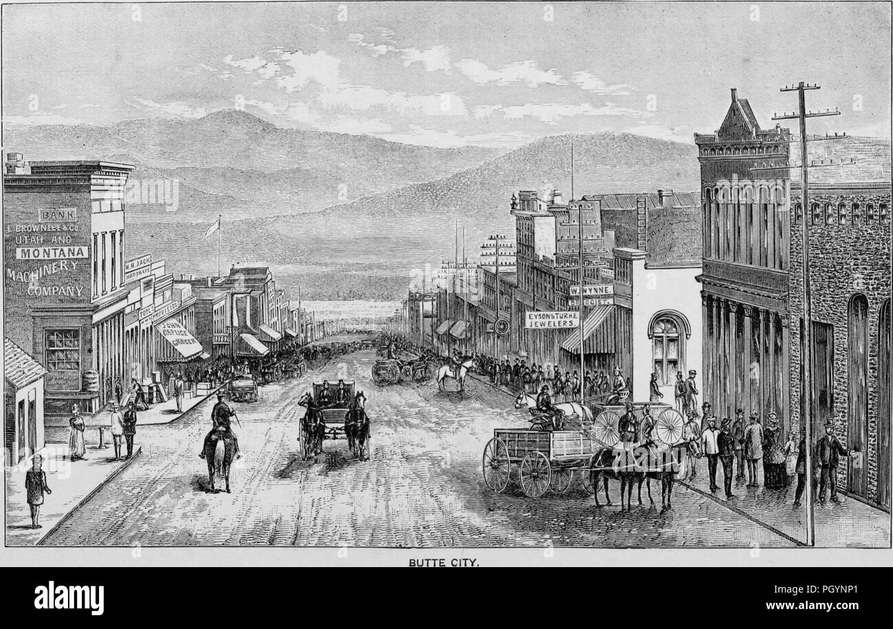 Black and white vintage print, captioned 'Butte City, ' depicting a busy main street, with people on horseback, driving wagons, and walking on the sidewalks, with storefronts on each side of the road, located in Butte, Montana, USA, and published in William Makepeace Thayer's volume 'Marvels of the New West', 1887. Courtesy Internet Archive. () Stock Photo