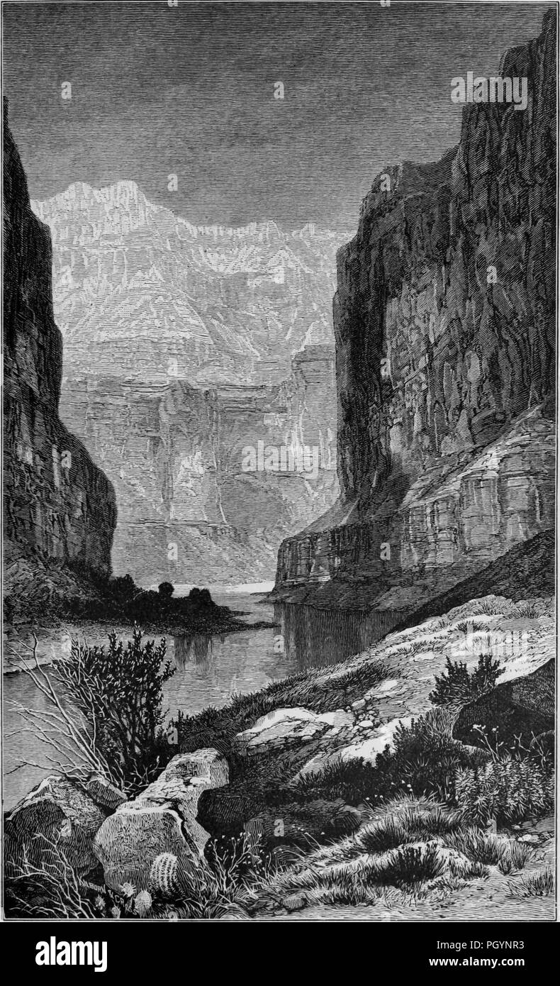 Black and white vintage print depicting the Colorado River winding through a gorge at Marble Canyon, with rocks and bushes in the foreground, and canyons looming in the background, located in northern Arizona, USA, and published in William Makepeace Thayer's volume 'Marvels of the New West', 1887. Courtesy Internet Archive. () Stock Photo