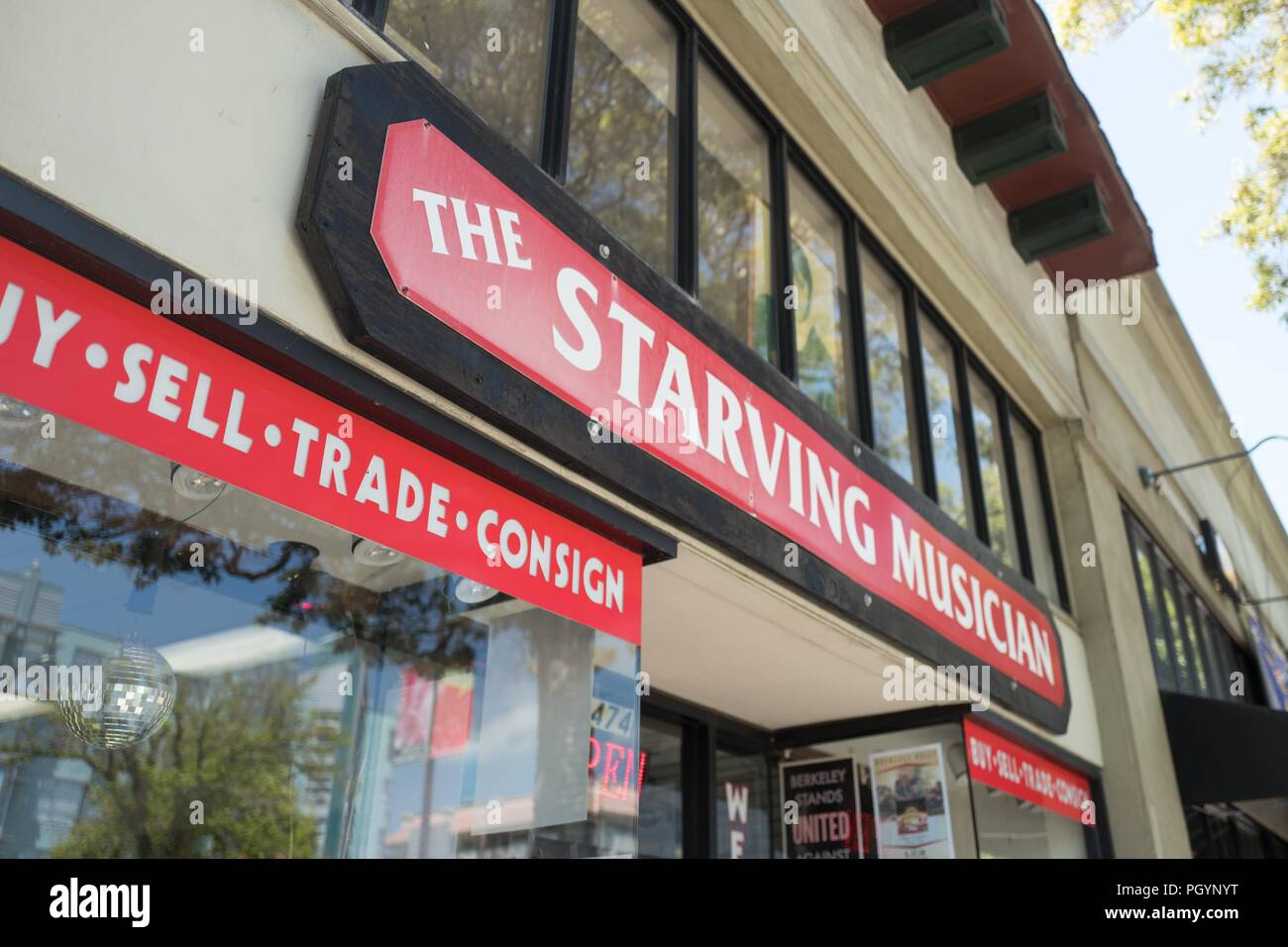 Sign on facade of the Starving Musician, an independent store for used musical equipment in downtown Berkeley, California, May 17, 2018. () Stock Photo