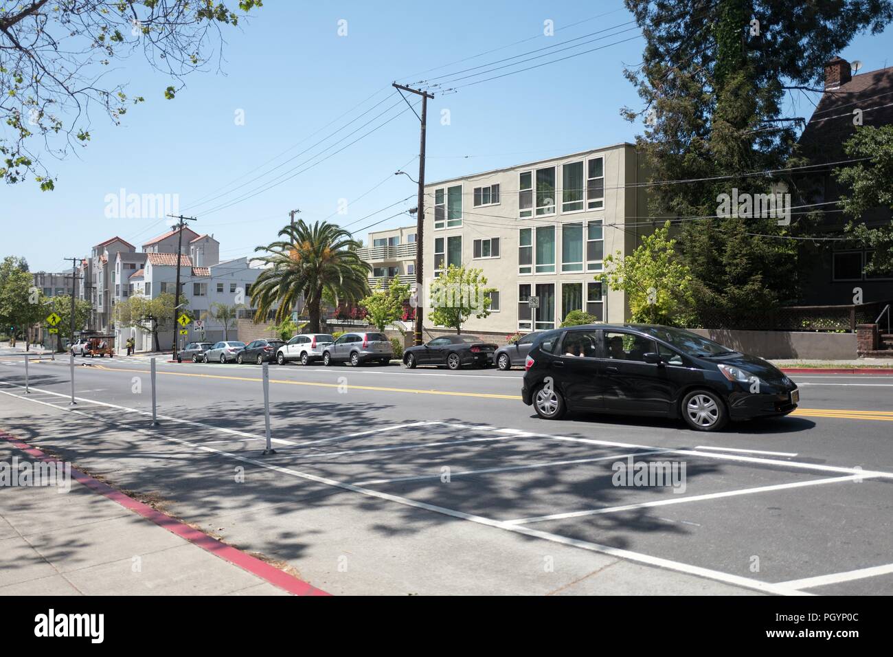 A black hybrid automobile drives past UC Berkeley on a sunny day in North Berkeley, California, May 21, 2018. () Stock Photo