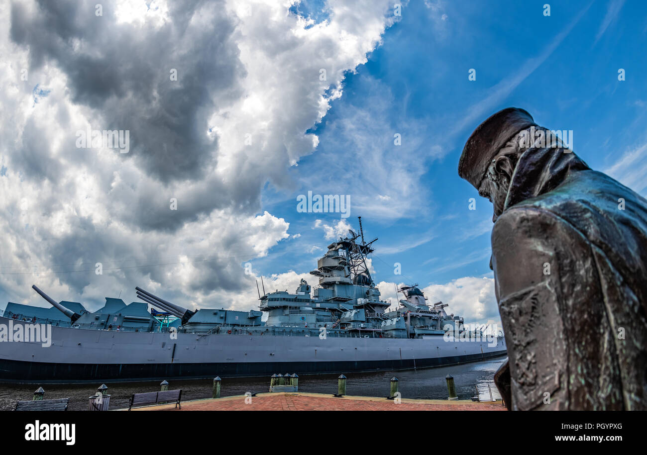 The lone sailor and the Battleship Wisconsin in Norfolk Virginia Stock Photo